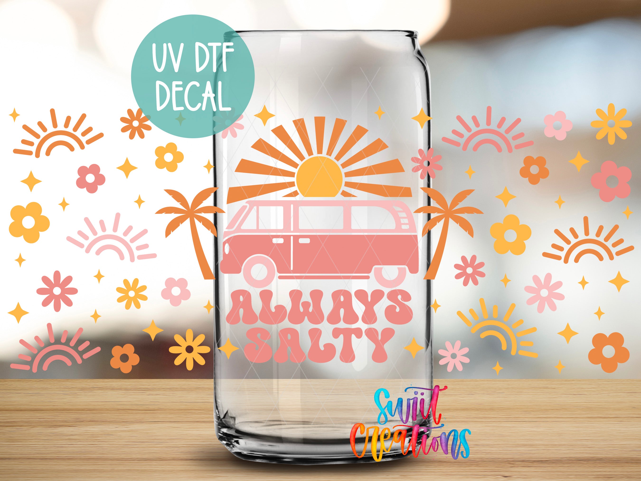 A glass with a UV decal featuring a van and the text "Always Salty" against a background of sun and flower designs.