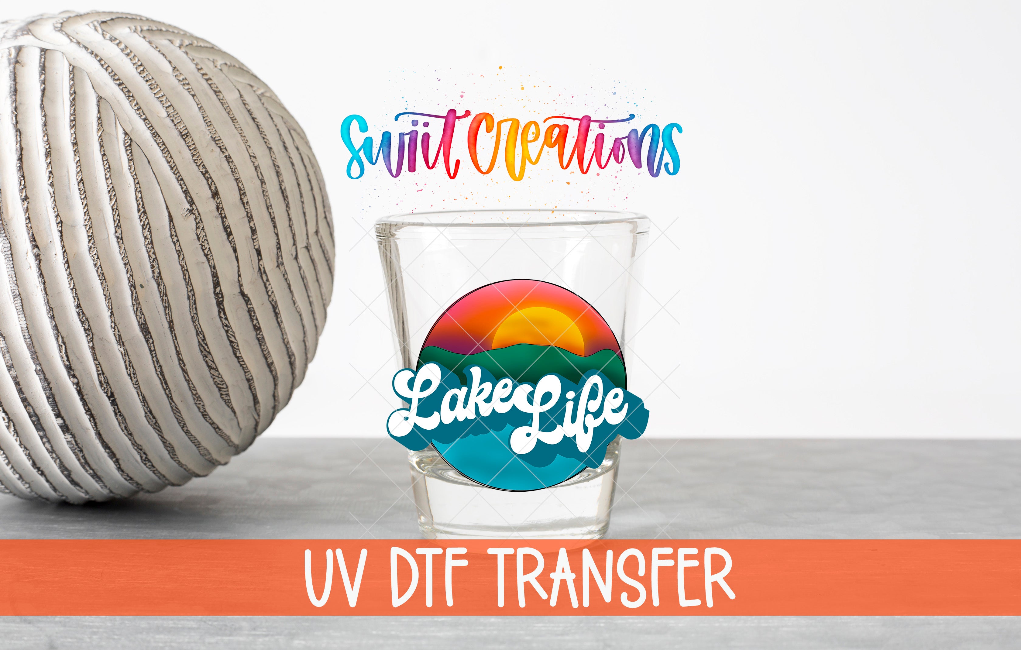 a glass with a colorful design, a ball, and text related to UV DFT transfer.