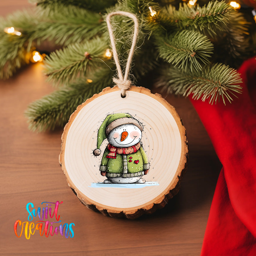 A wooden ornament featuring a snowman is hanging on a Christmas tree, with a red cloth visible in the background.