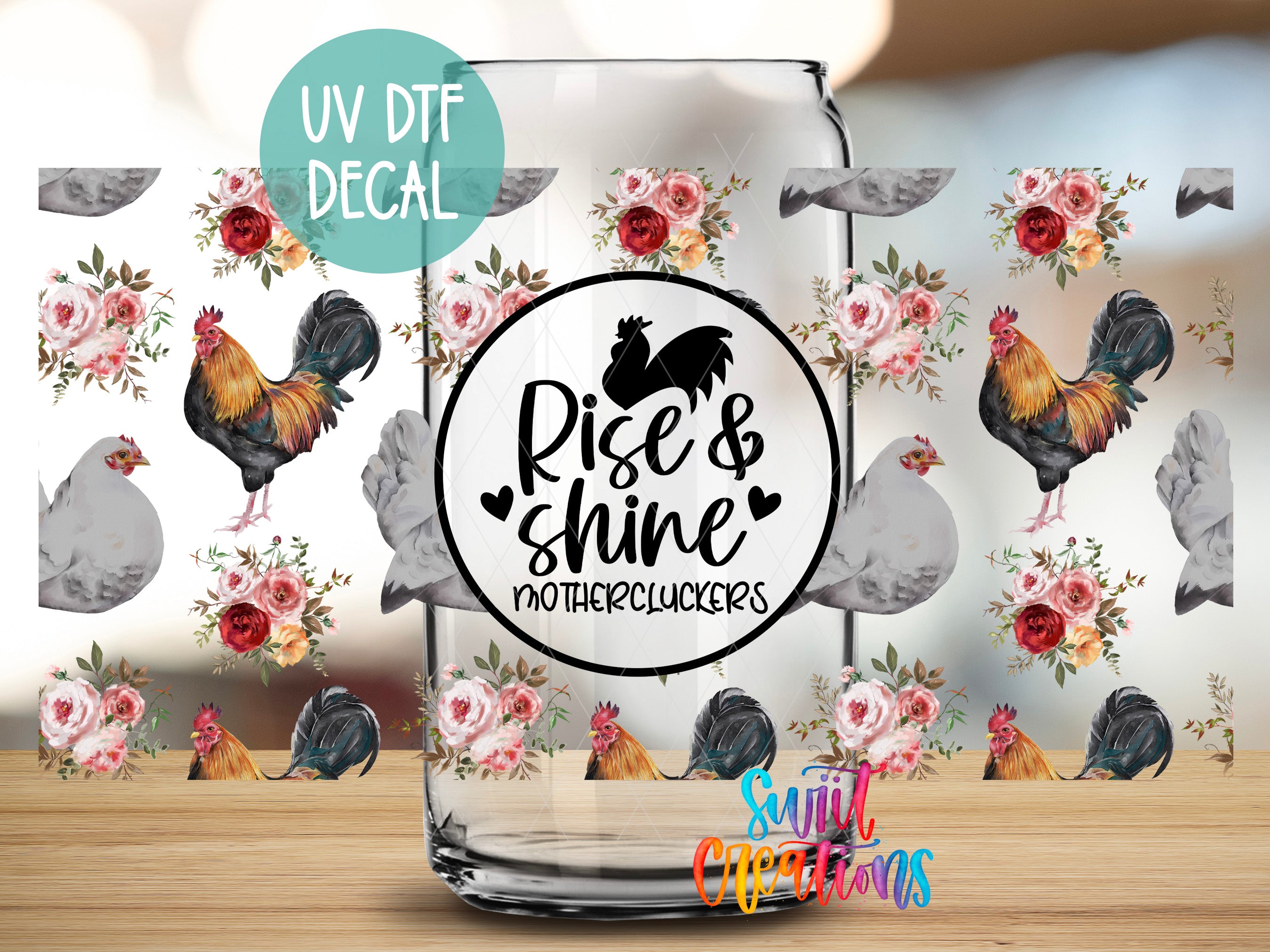 a glass jar with a floral pattern and a black and white rooster design on it. The jar has a UV decal on it that says "Rise & Shine Mothercluckers".