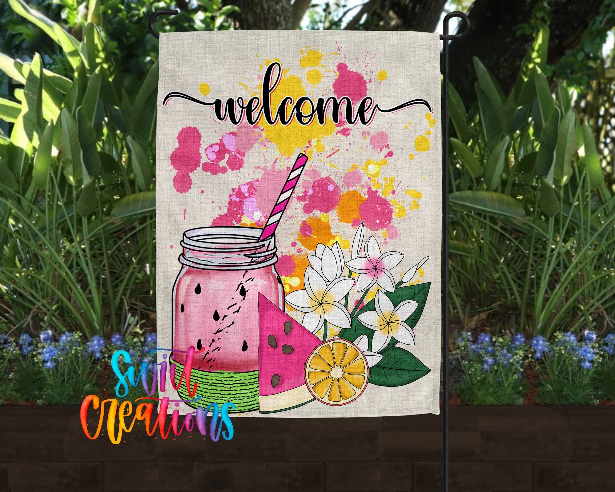 A colorful welcome sign featuring a mason jar with a straw, watermelon slices, and flowers, set against a backdrop of lush greenery and flowers.