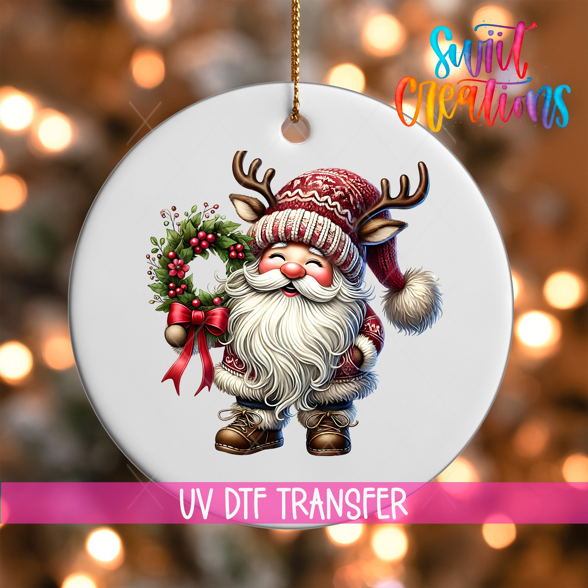 A white ornament featuring a smiling Santa Claus figure holding a wreath and wearing antlers, with a pink ribbon around the ornament.