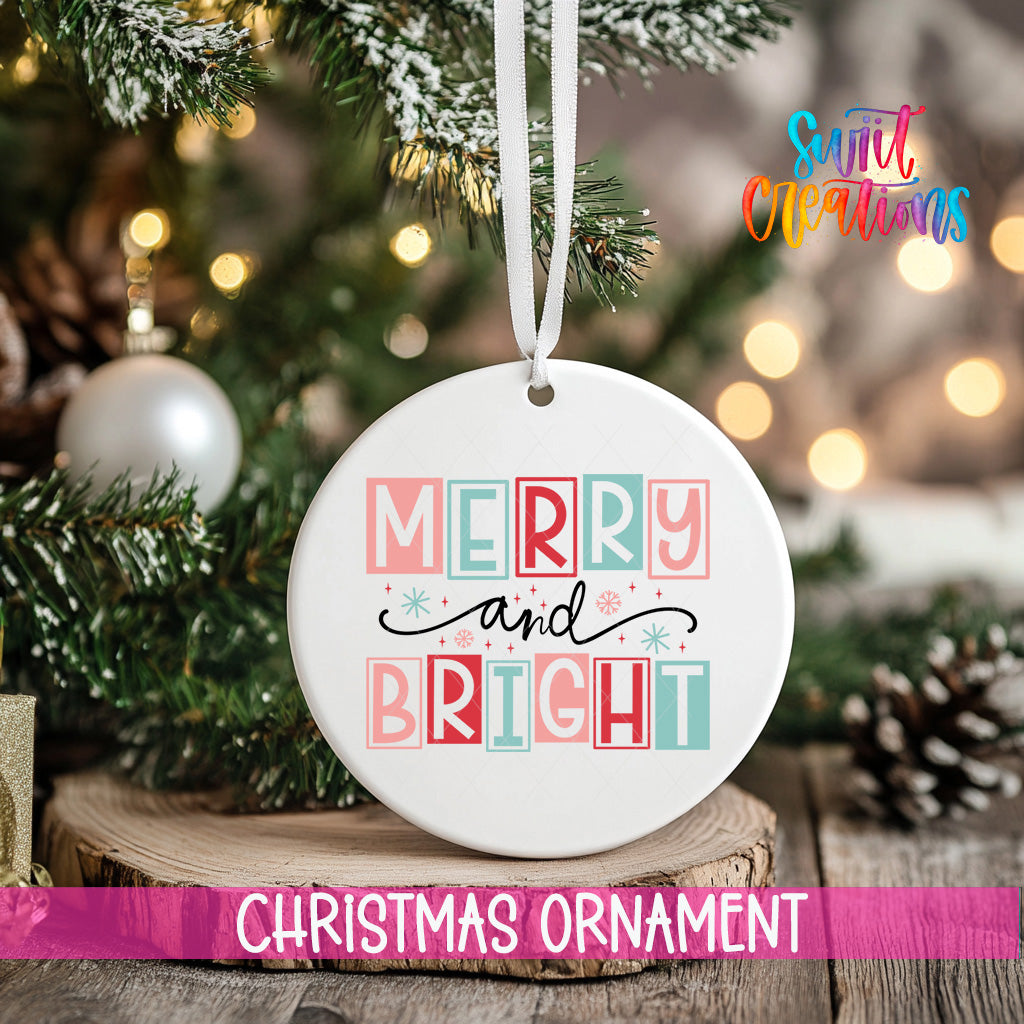 A white Christmas ornament with the text "MERRY AND BRIGHT" is hanging from a tree branch, surrounded by pine cones and other holiday decorations.