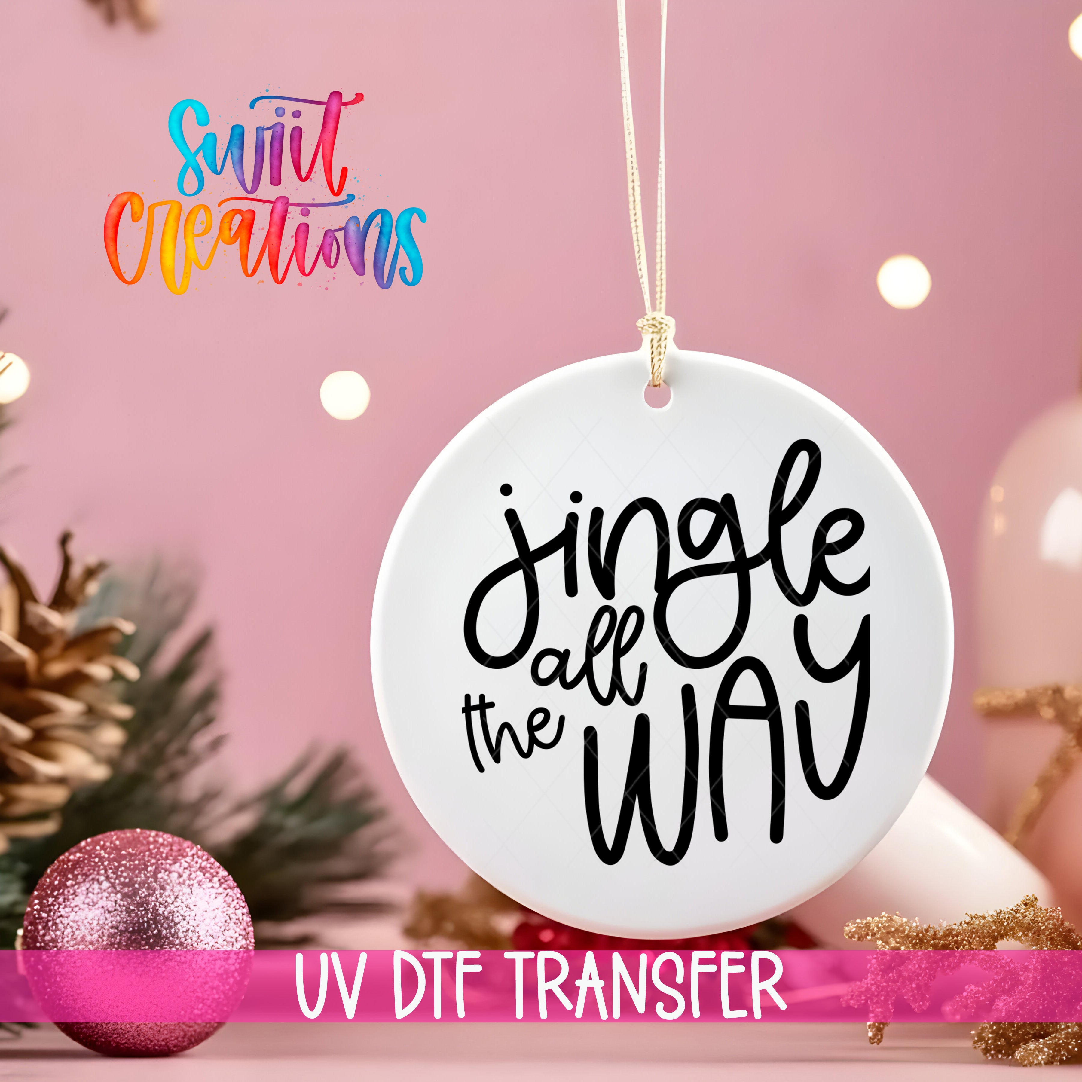 A white ornament with the text "Jingle all the way" is hanging on a string against a pink background, with Christmas decorations and a pink glitter ornament visible in the background.