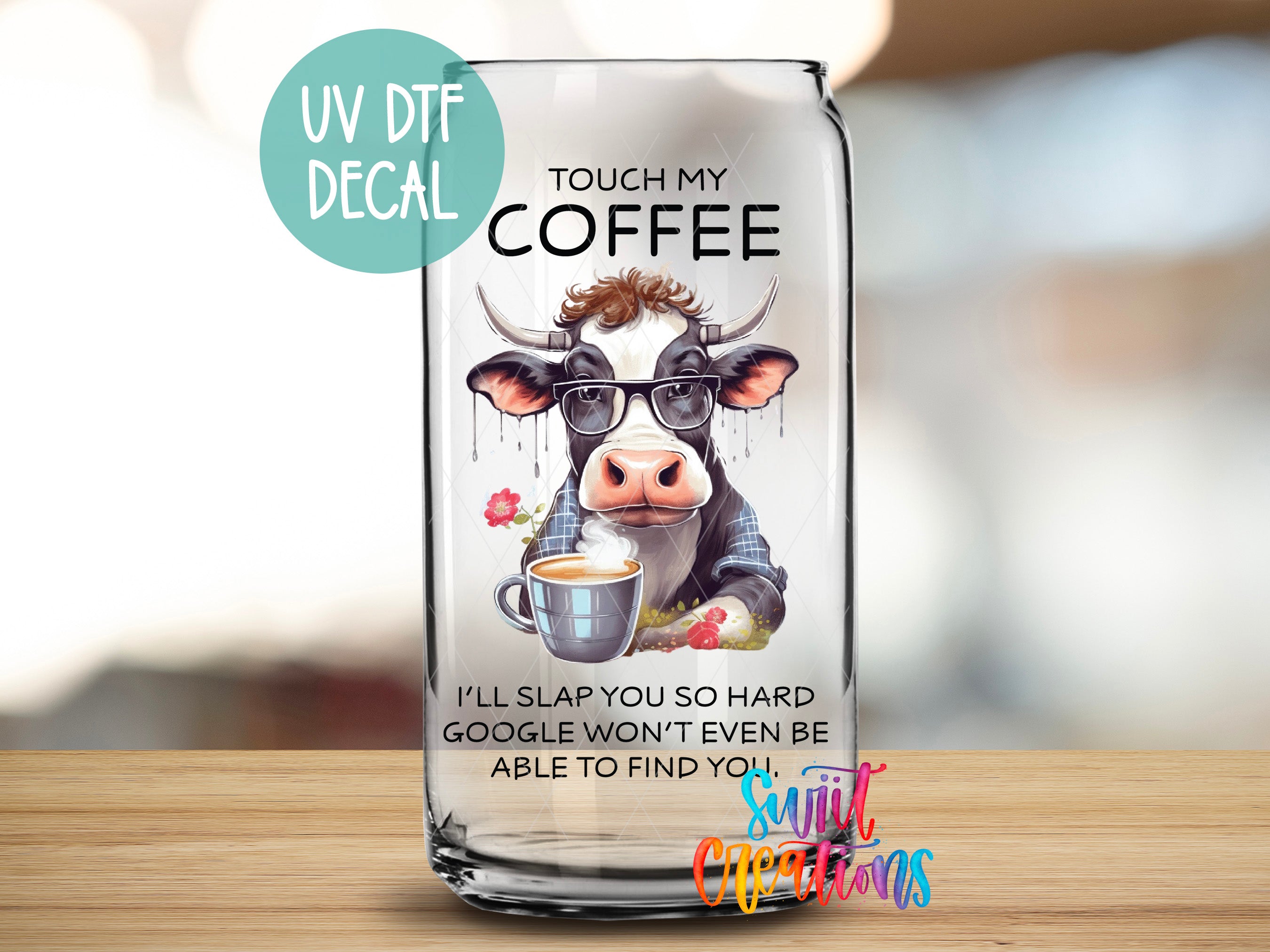 a glass bottle with a picture of a cow on it