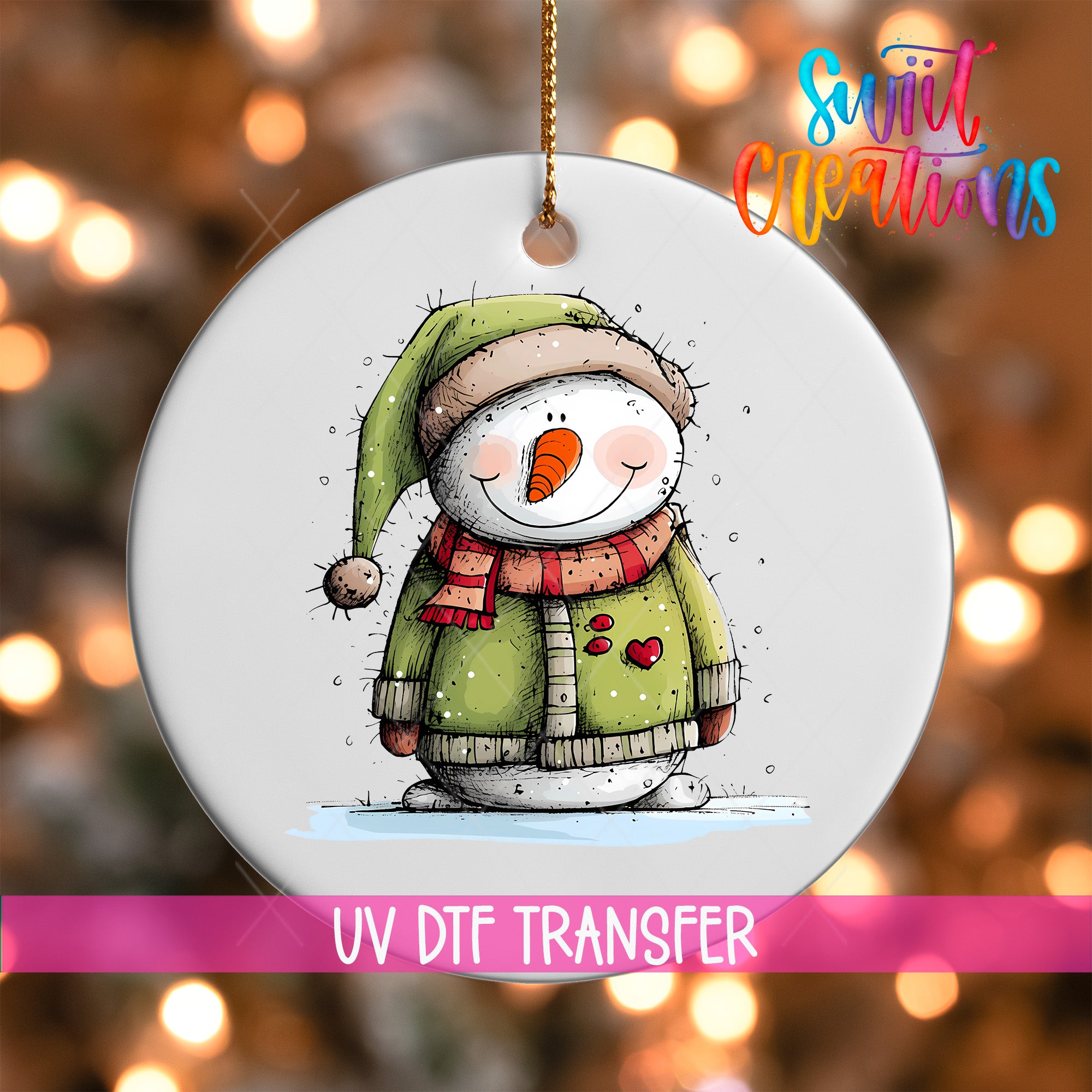 A snowman ornament with a green hat and scarf, and a red heart on its chest, is hanging against a background of colorful lights.