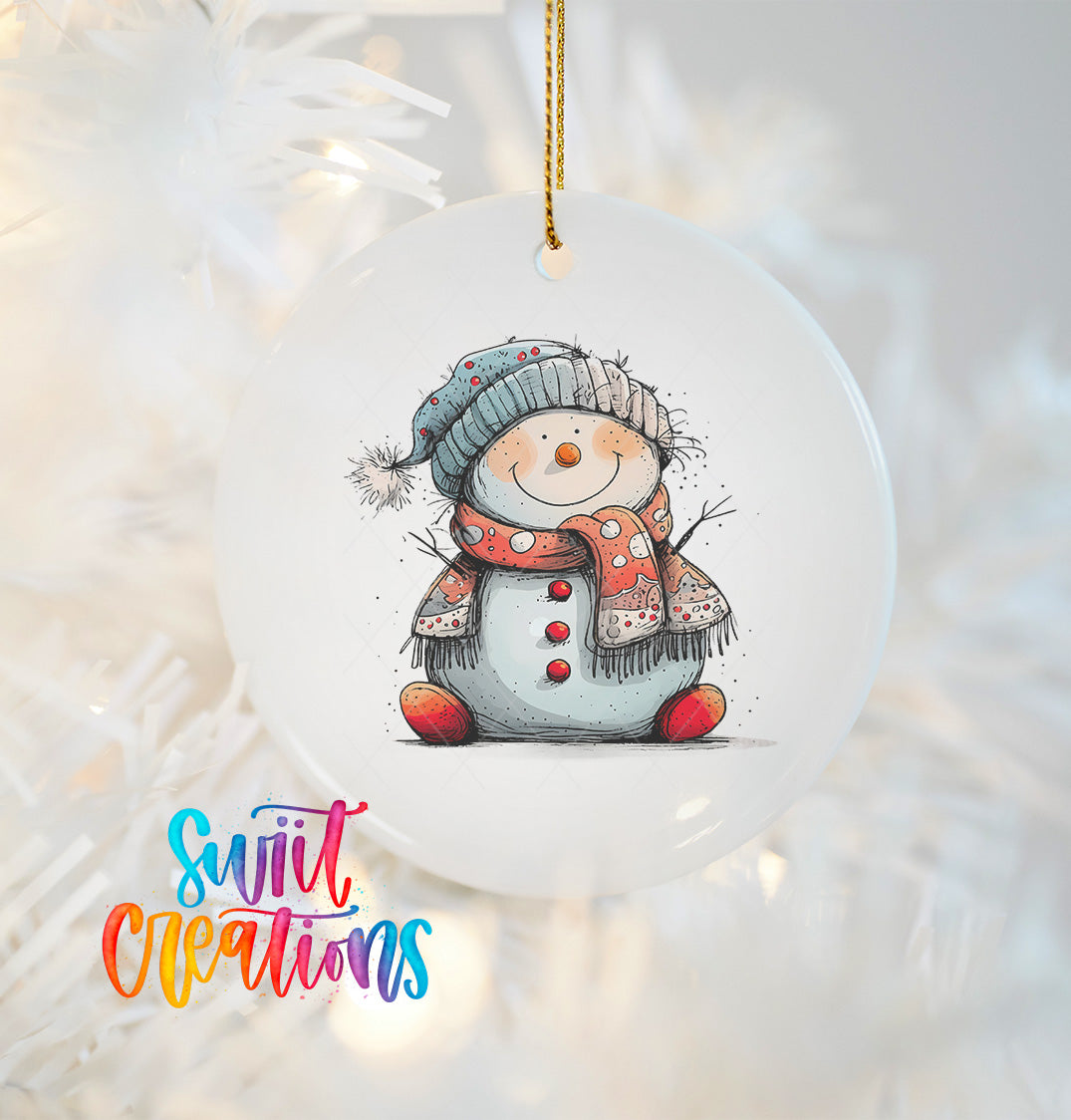 A white ornament featuring a smiling snowman wearing a hat and scarf, hanging on a Christmas tree.