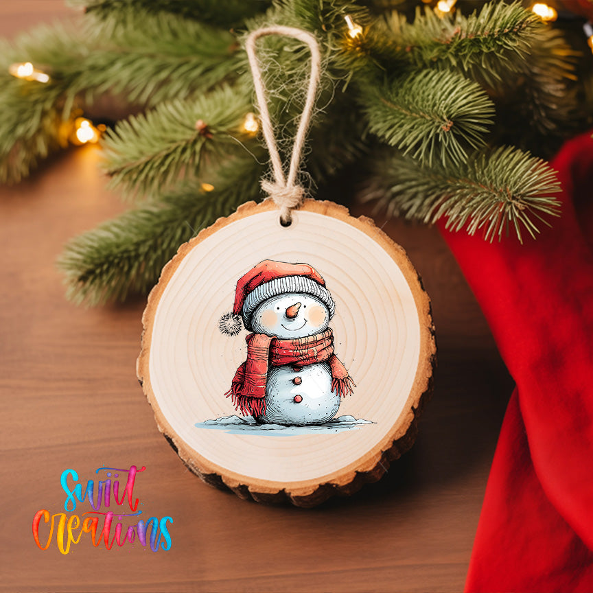 A wooden ornament featuring a snowman is hanging on a Christmas tree, with a red cloth visible in the background.