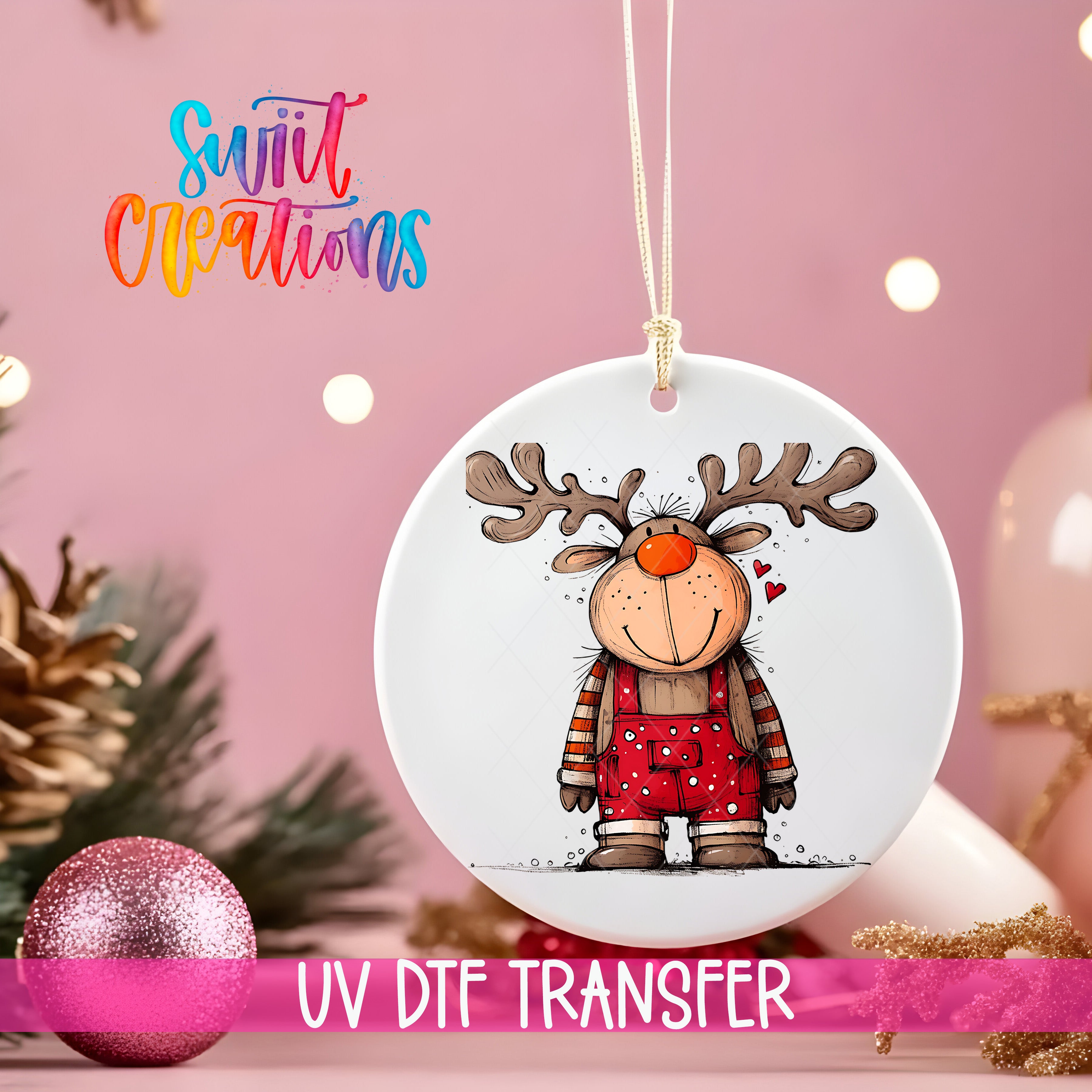 A white ornament with a cartoon reindeer design hangs against a pink background, with Christmas decorations and a pink glitter ball in the foreground.