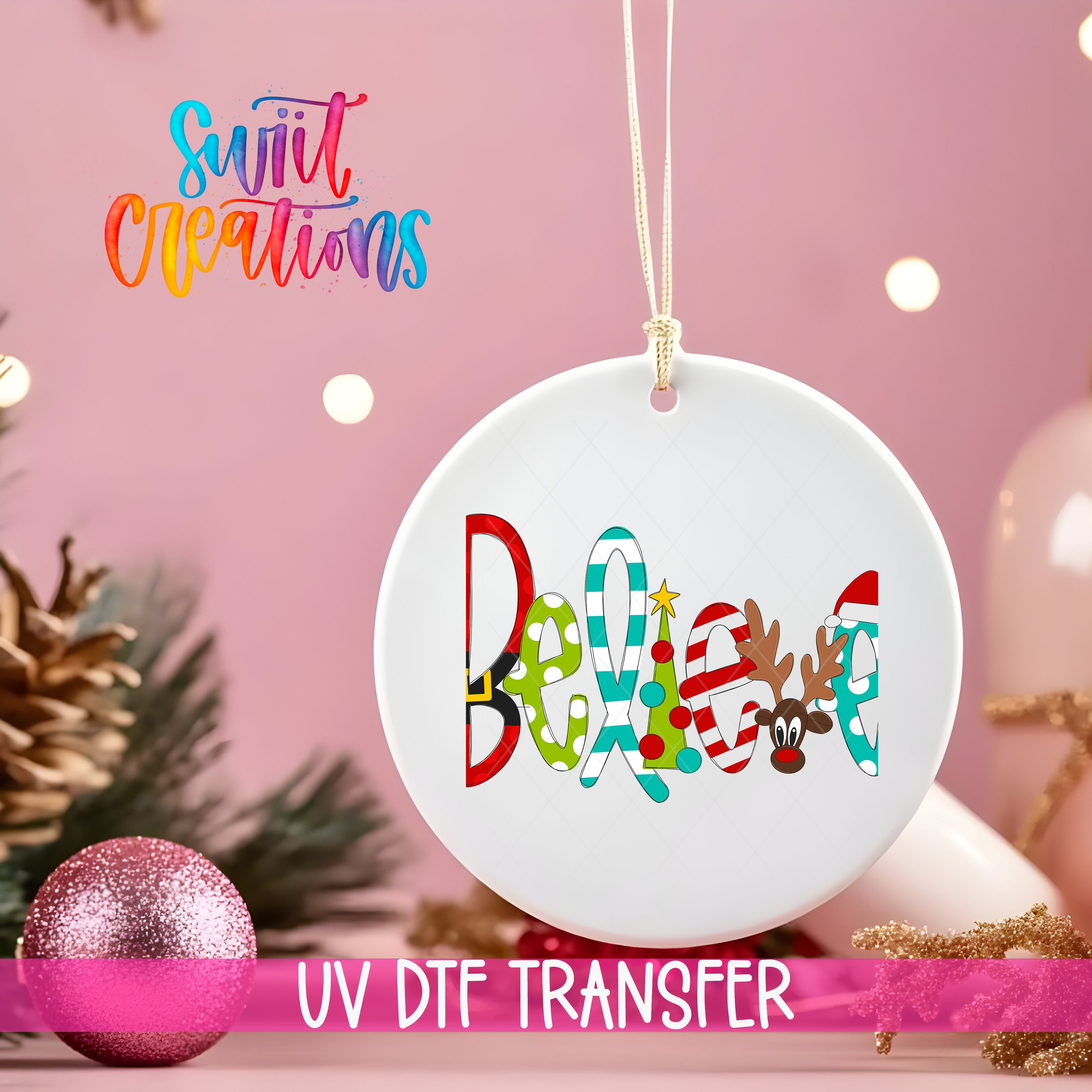 A white ornament with the word "Belief" written on it, hanging on a string. The ornament is surrounded by Christmas decorations, including a pink glitter ornament and pine cones.