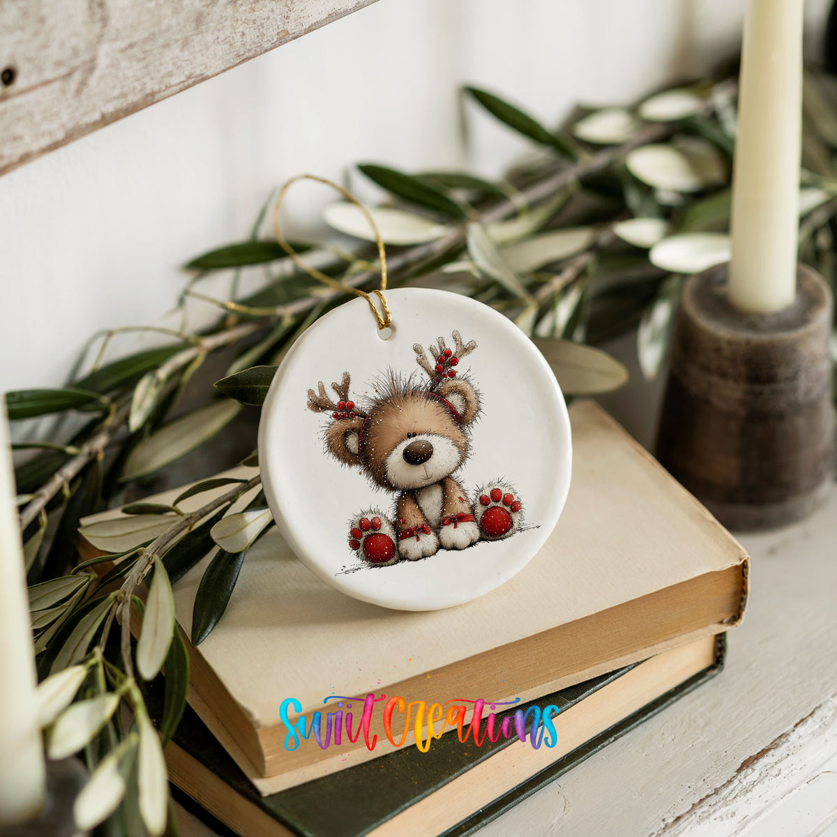 reindeer teddy bear with red Christmas ornaments ceramic Christmas ornament styled on stacked books with greenery