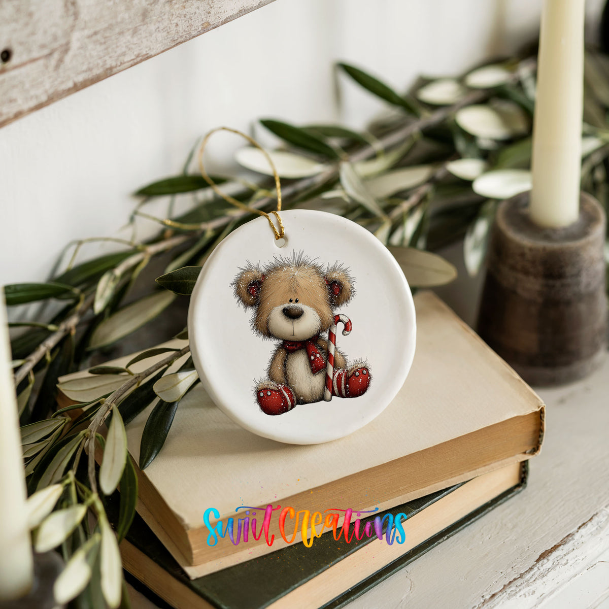 teddy bear with a candy cane and red Christmas ornament ceramic Christmas ornament styled on stacked books with greenery