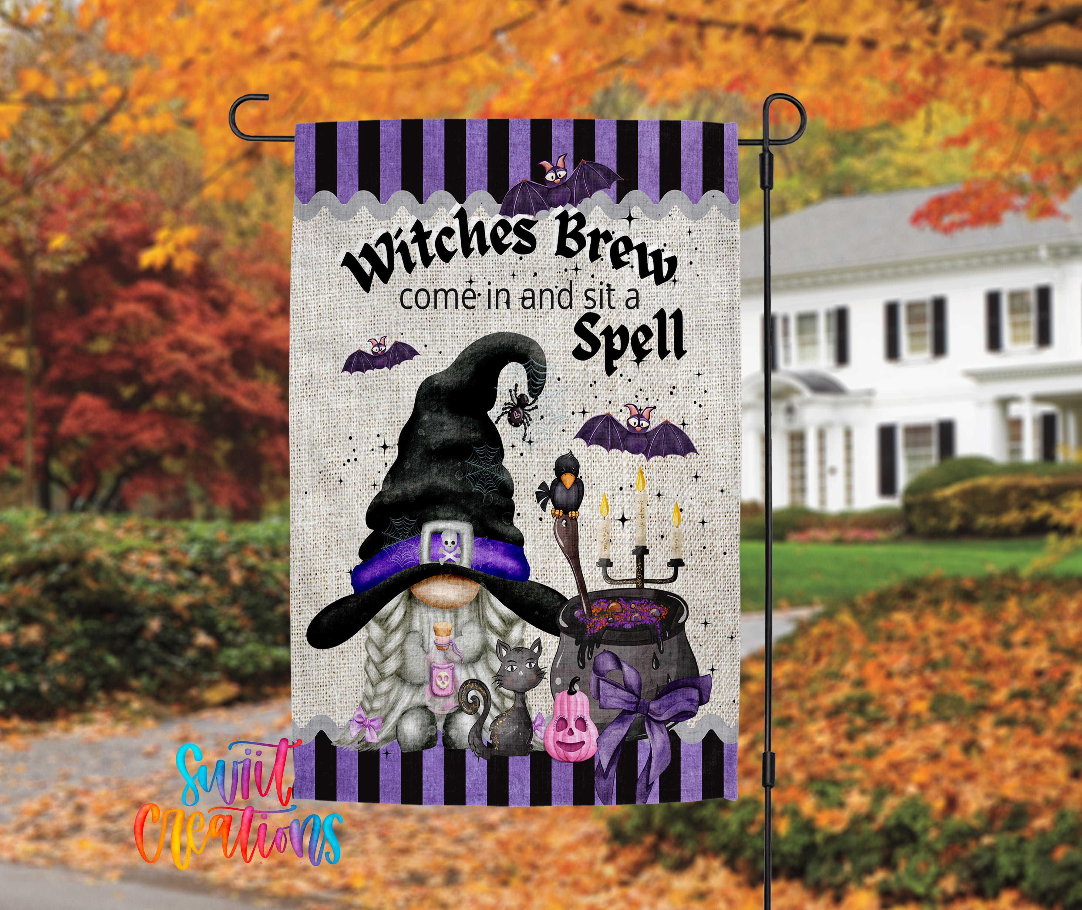 A Halloween-themed garden flag featuring a gnome, a witch's cauldron, bats, and a pumpkin, with the text "Witches Brew come in and sit a Spell".