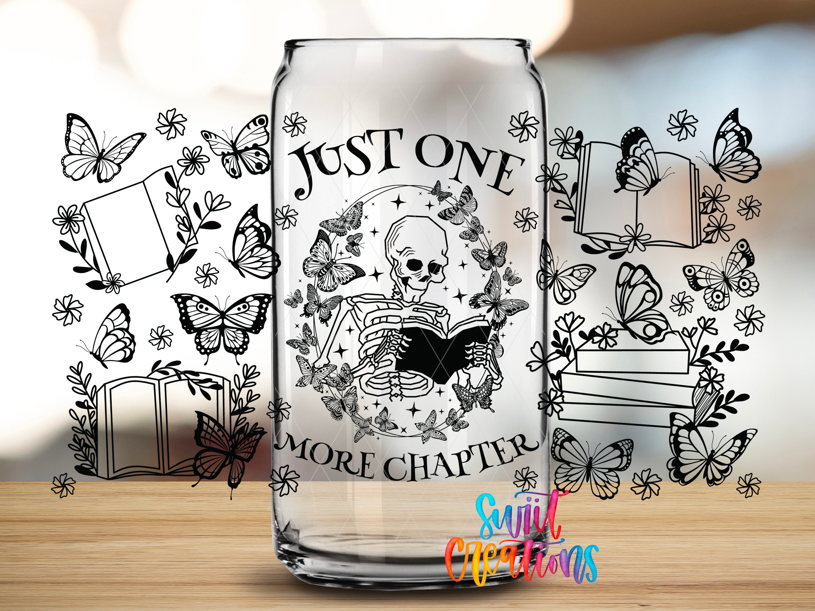 A glass can with a design featuring a skeleton reading a book surrounded by butterflies and flowers, with the text "Just one more chapter" and "More chapter" written on it.
