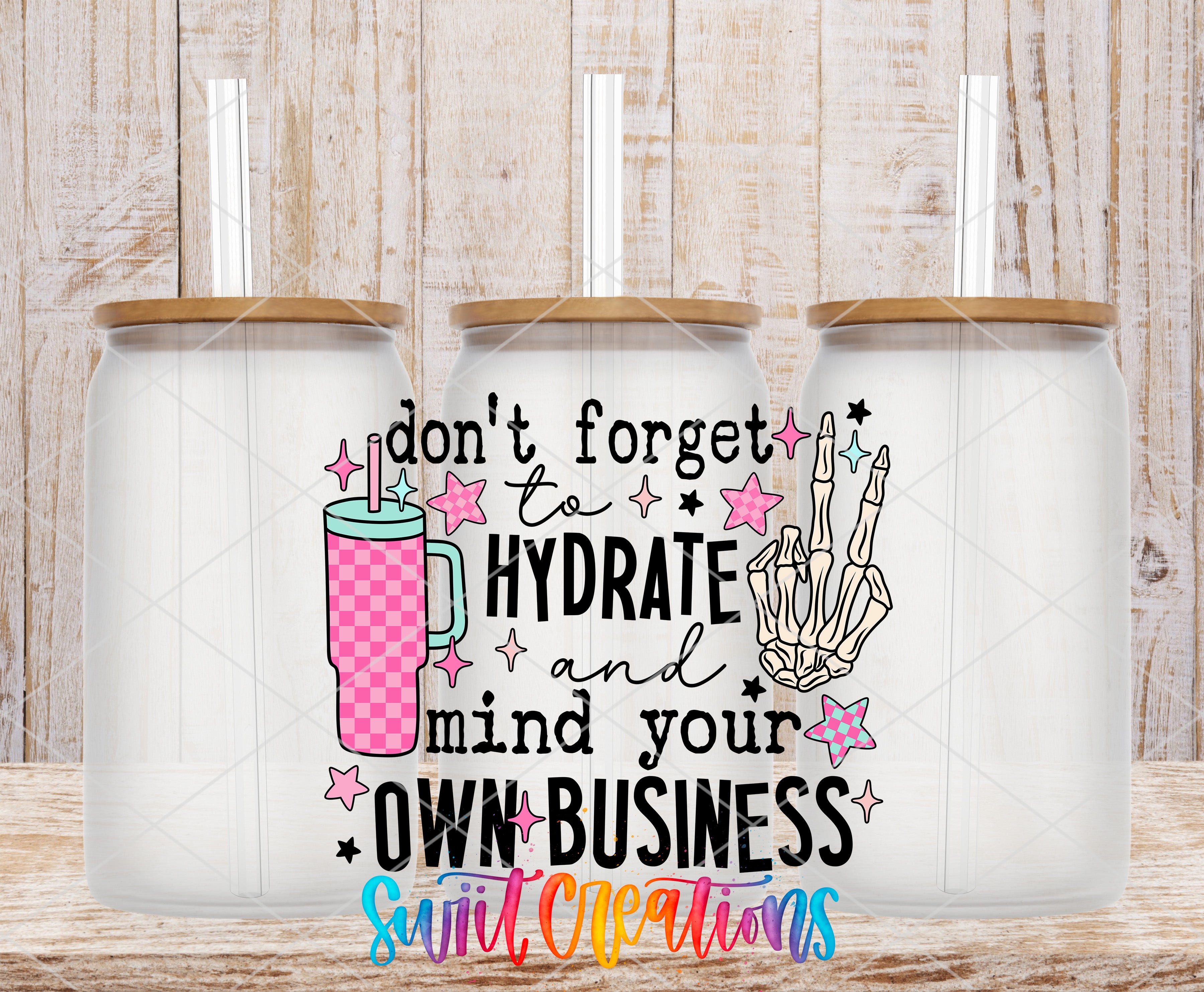 Swiit Creations UV DTF Hydrate and Mind Your Business transfer shown on a clear glass can set