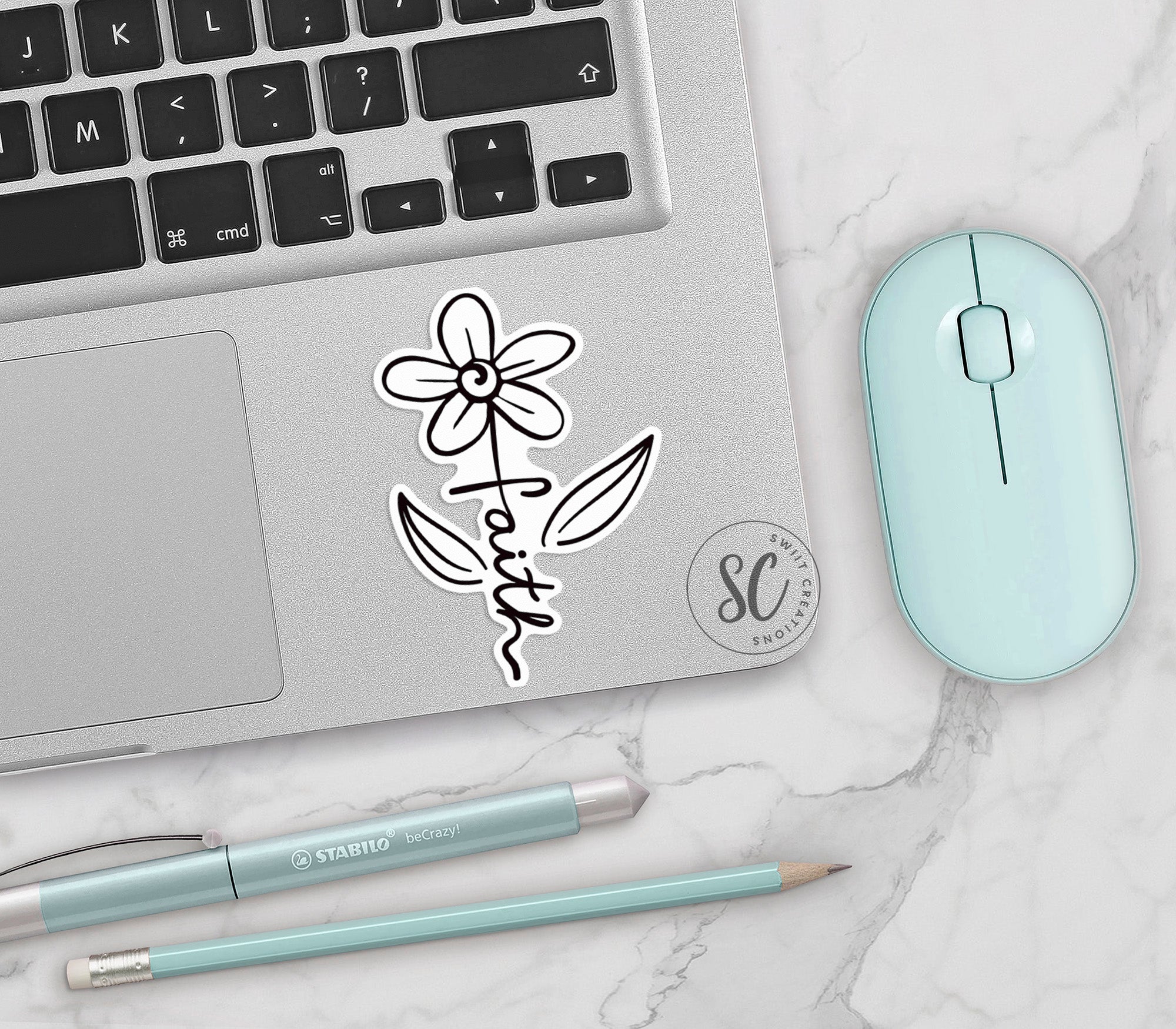 a laptop with a sticker of a flower on it