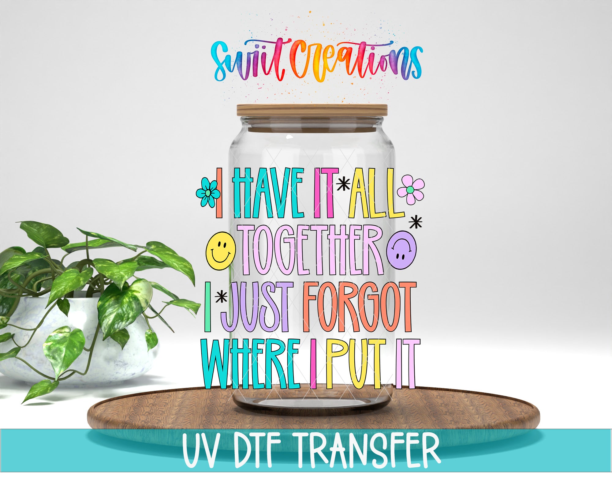 a colorful text overlay on a glass jar, accompanied by a potted plant and a wooden tray, with the text "Swit Creations" and "UV DFT Transfer" at the bottom.