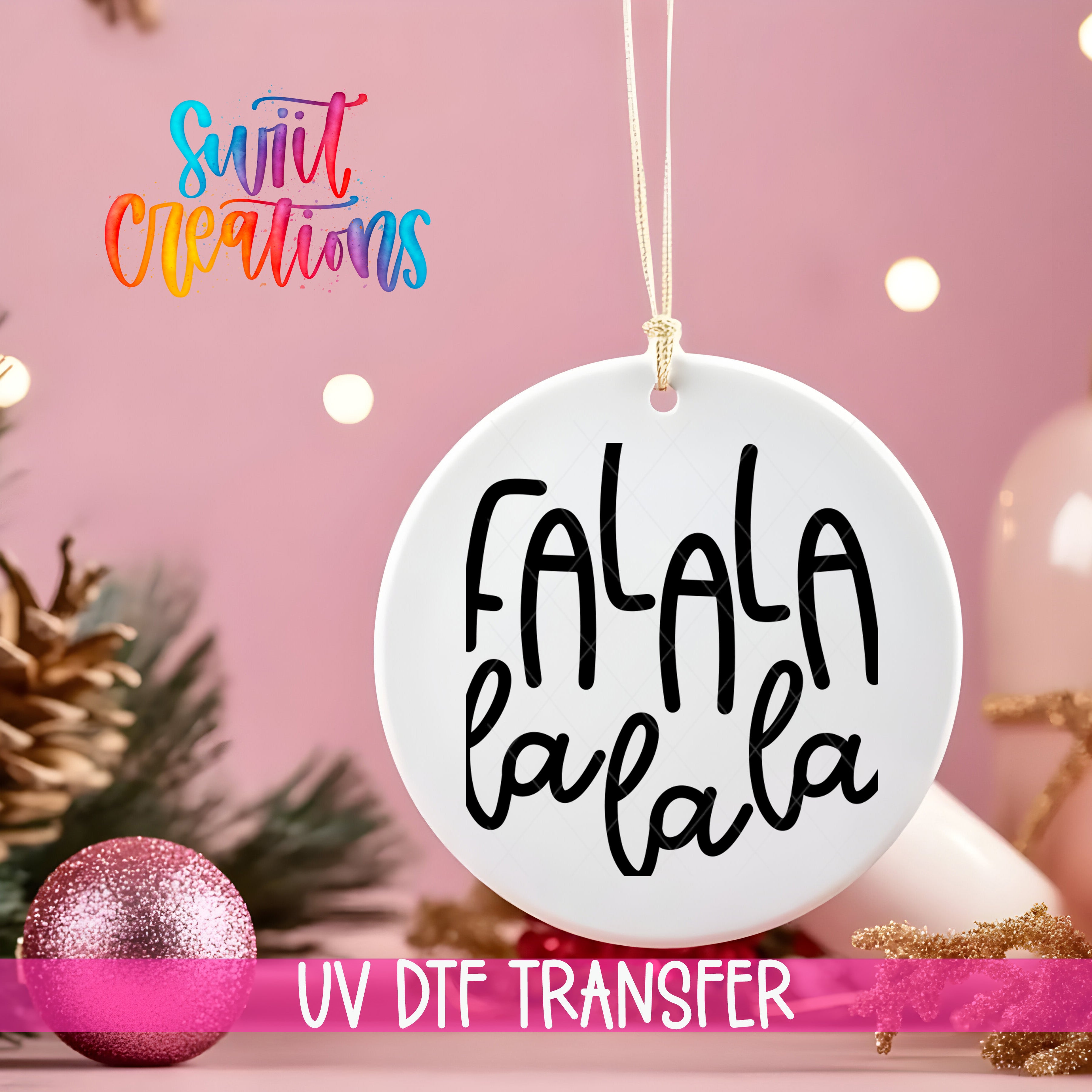 A white ornament with the text "FALA" in black cursive font, hanging on a string against a pink background with Christmas decorations in the background.