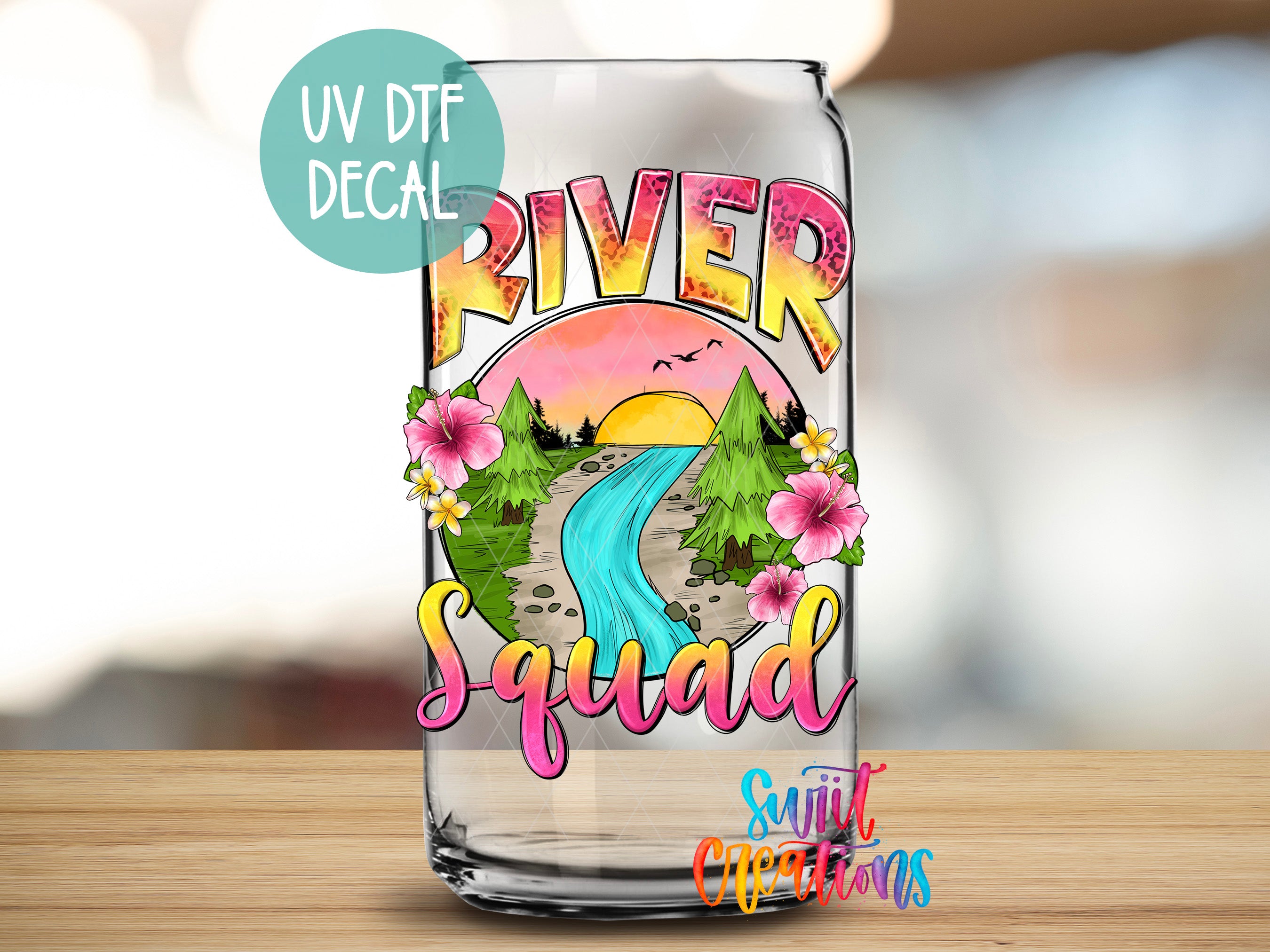 a clear glass with a picture of a river and flowers