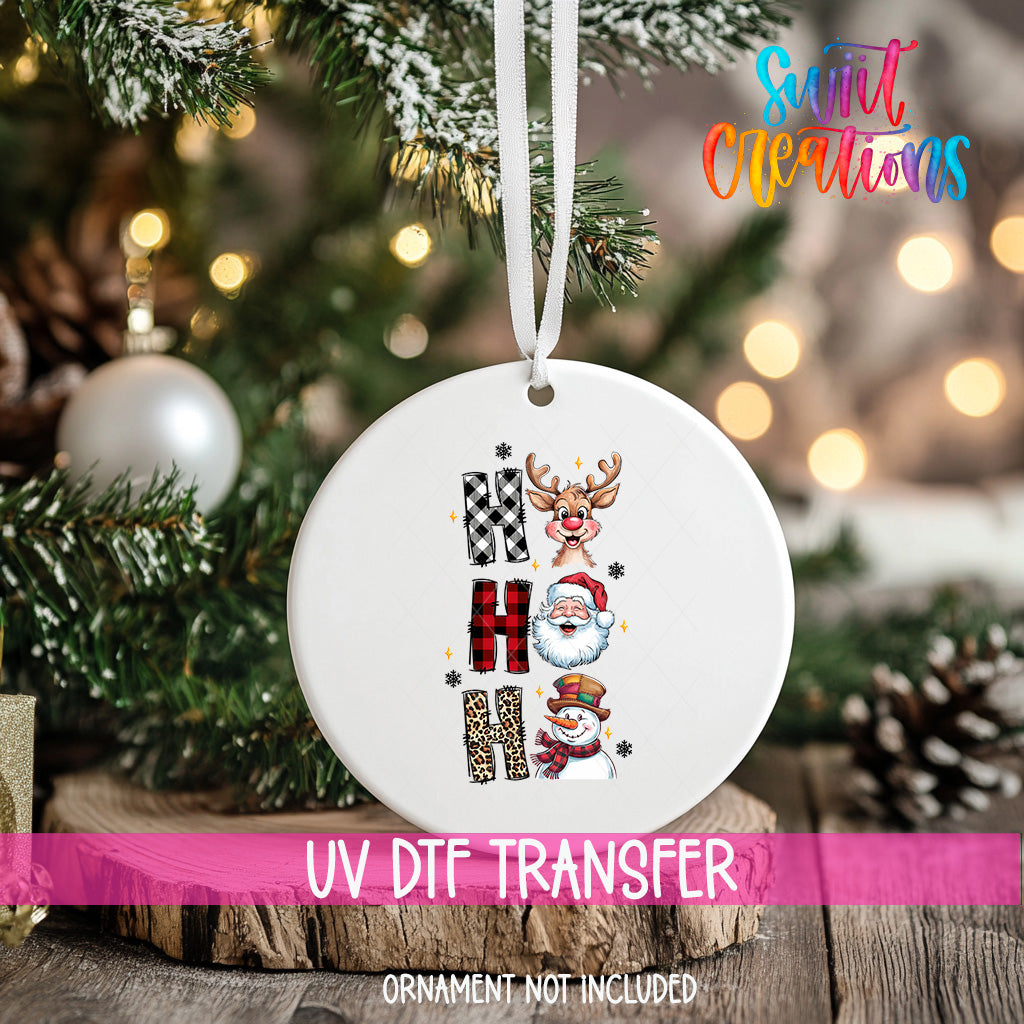 A white ornament with a Christmas tree in the background, featuring a snowman, reindeer, and Santa Claus.