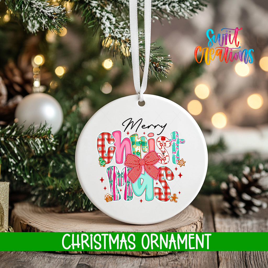 A white Christmas ornament with the text "Merry Christmas" and colorful graphics hangs on a tree branch.