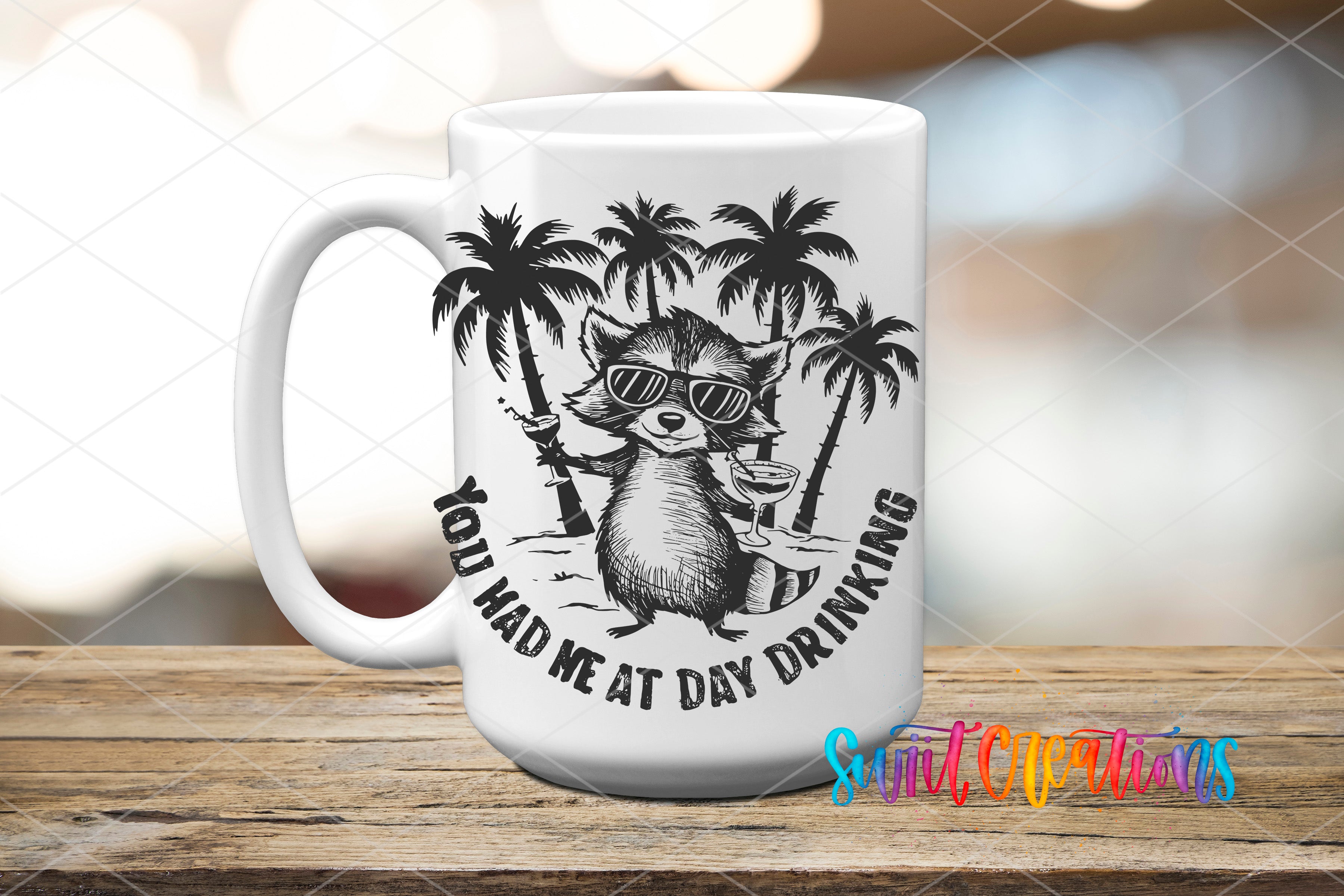 A white mug with a black and white illustration of a raccoon wearing sunglasses and holding a drink, surrounded by palm trees, with the text "You had me at day drinking" printed on it.