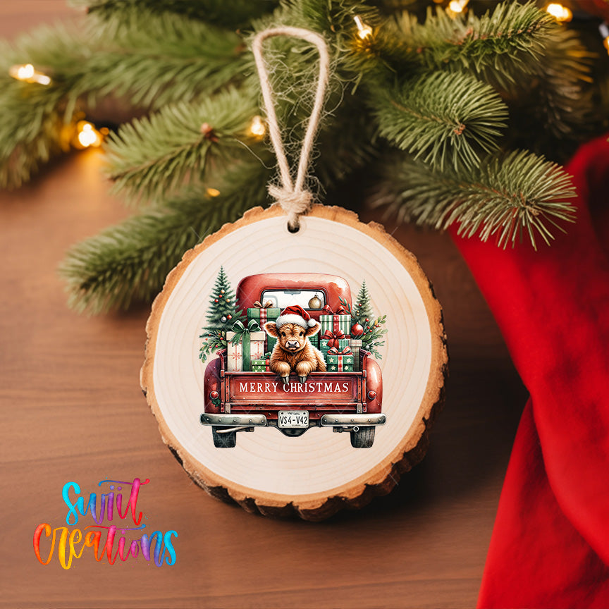 A wooden ornament hanging from a Christmas tree, featuring a dog in a Santa hat sitting in the back of a red truck decorated with Christmas presents.