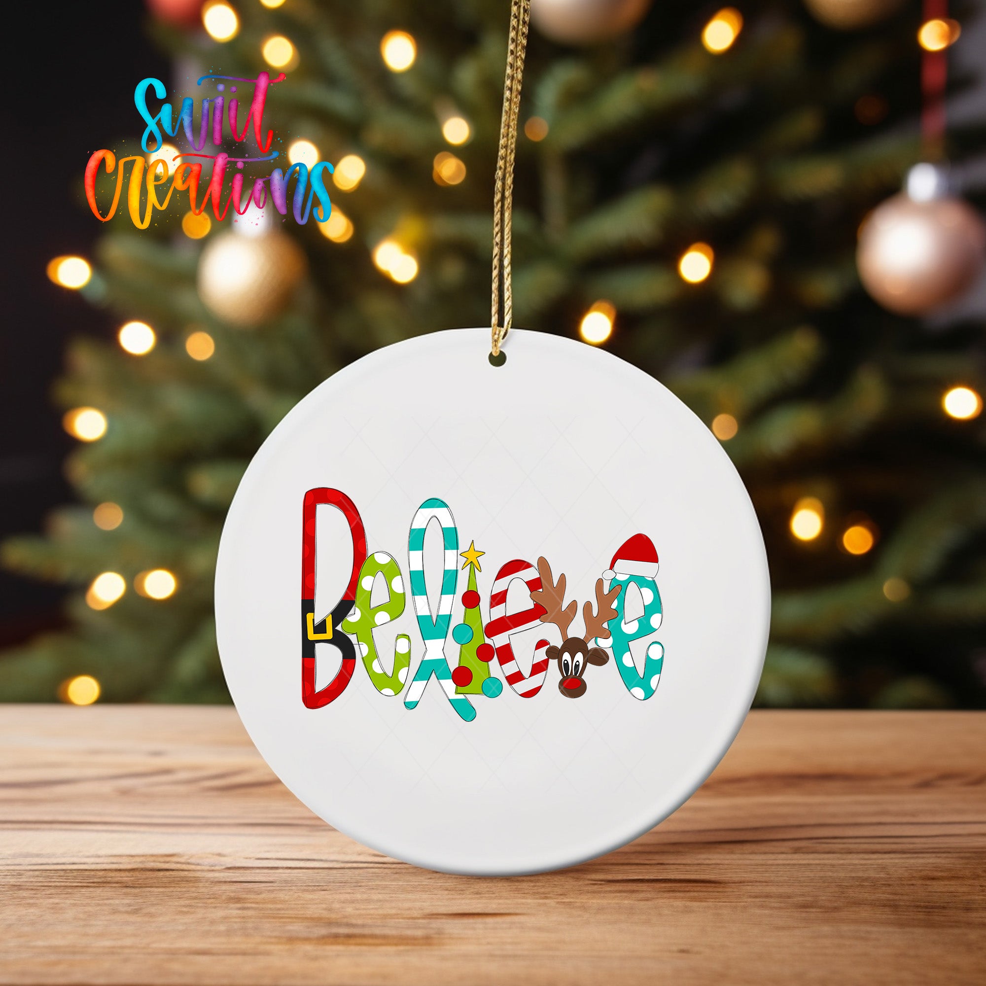 A white ceramic ornament with the word "Believe" written on it, hanging from a string.