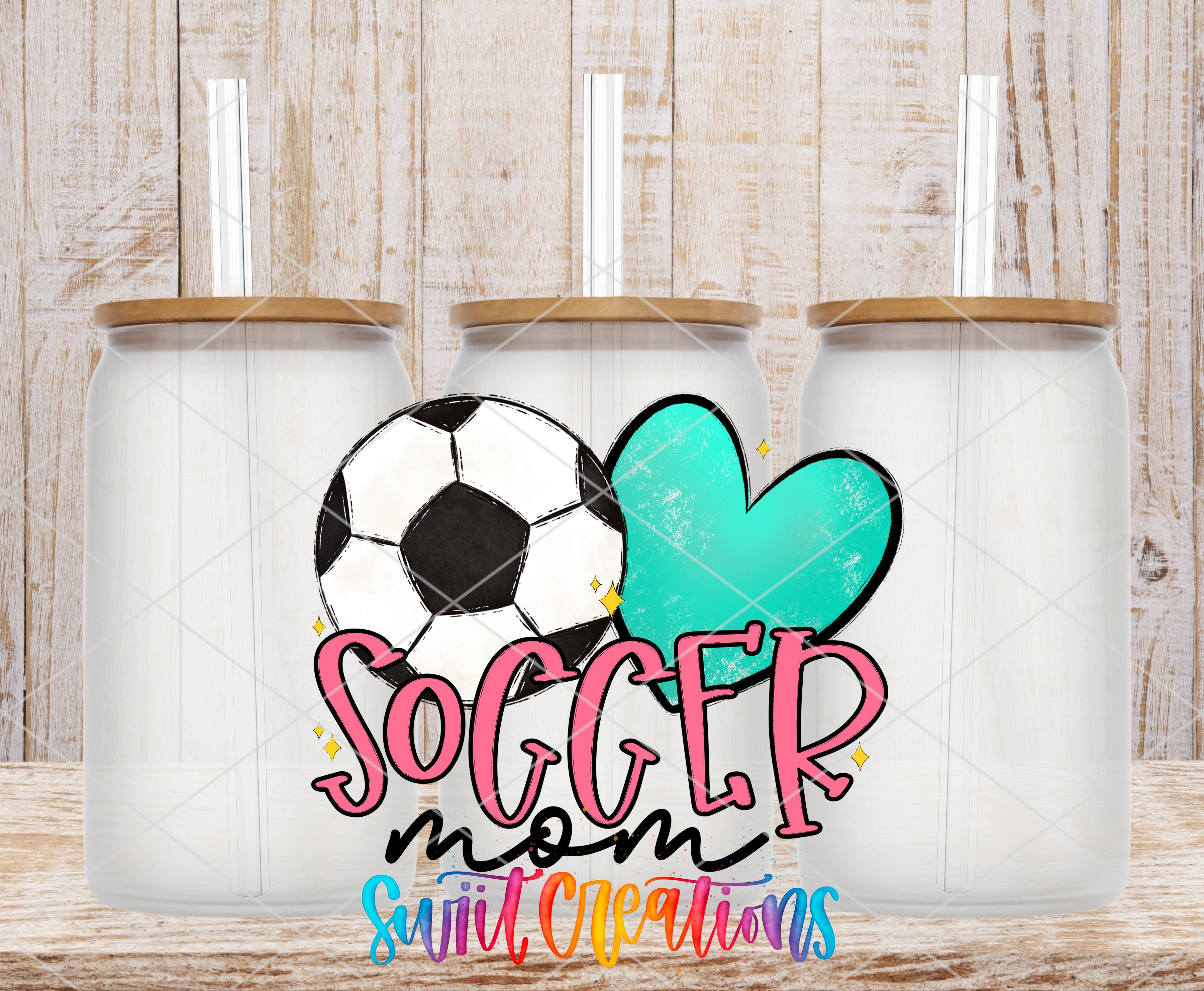 three glass jars with lids, each containing a straw, arranged in a row. The jars are set against a wooden background. The text "SOCCER mom" is prominently displayed in the center of the image, with a heart and a soccer ball graphic to the left and right of the text.