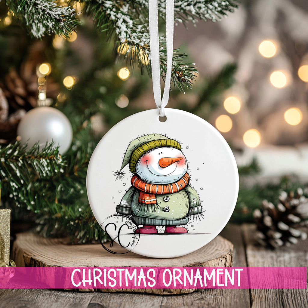 a snowman ornament hanging from a christmas tree