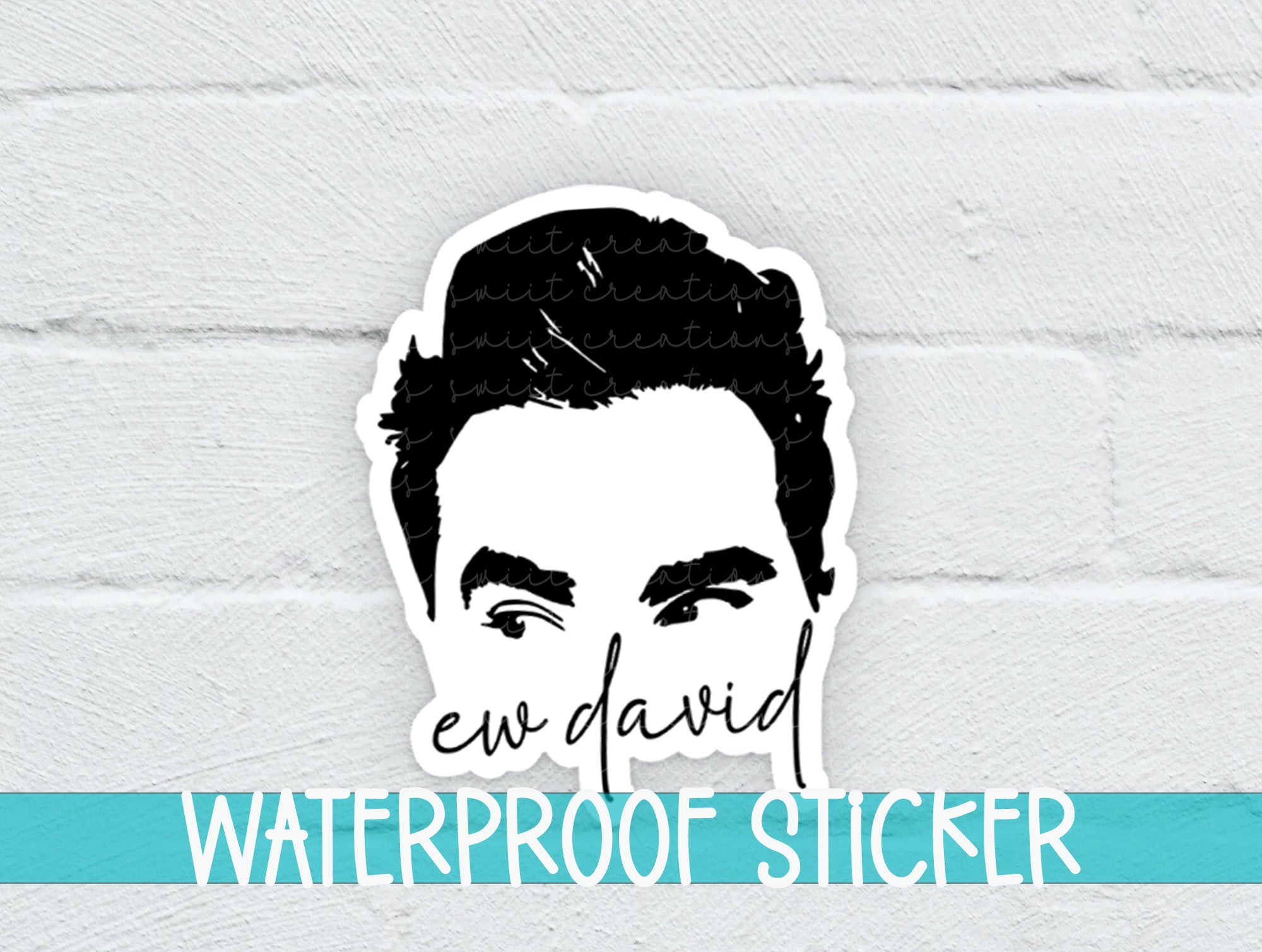 a sticker of a man's face on a white brick wall