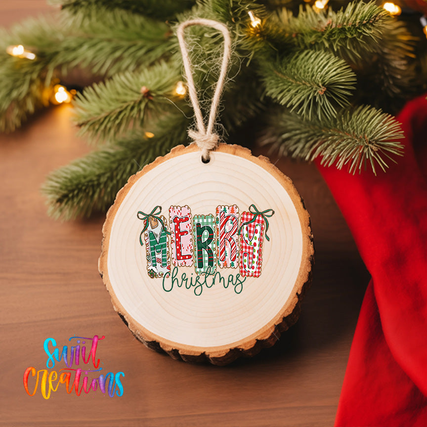 A wooden ornament with the word "MERRY CHRISTMAS" written on it, hanging on a Christmas tree.