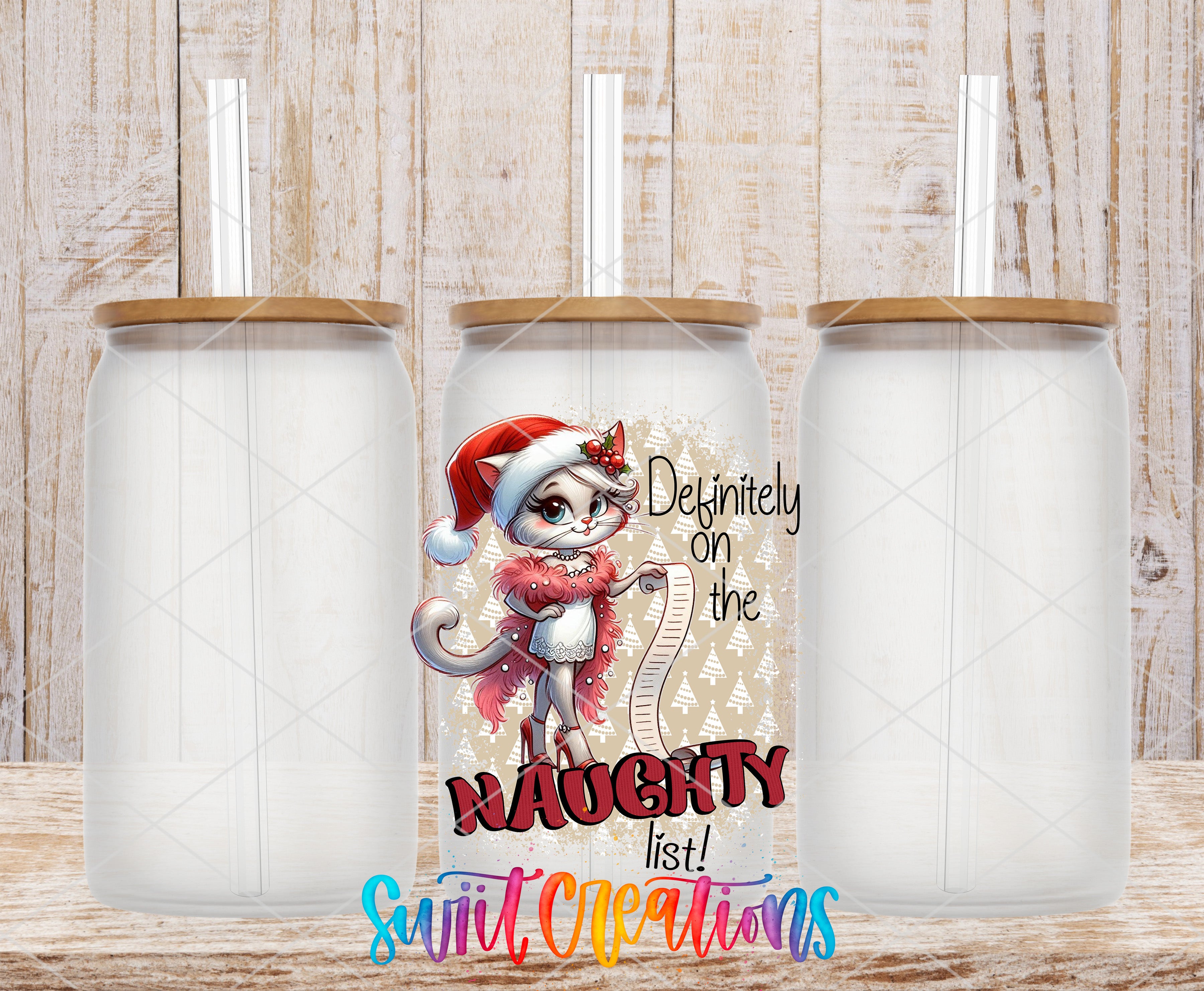 a clear glass tumbler with a cartoon cat wearing a Santa hat and scarf, along with the text "Definitely on the Naughty list!"