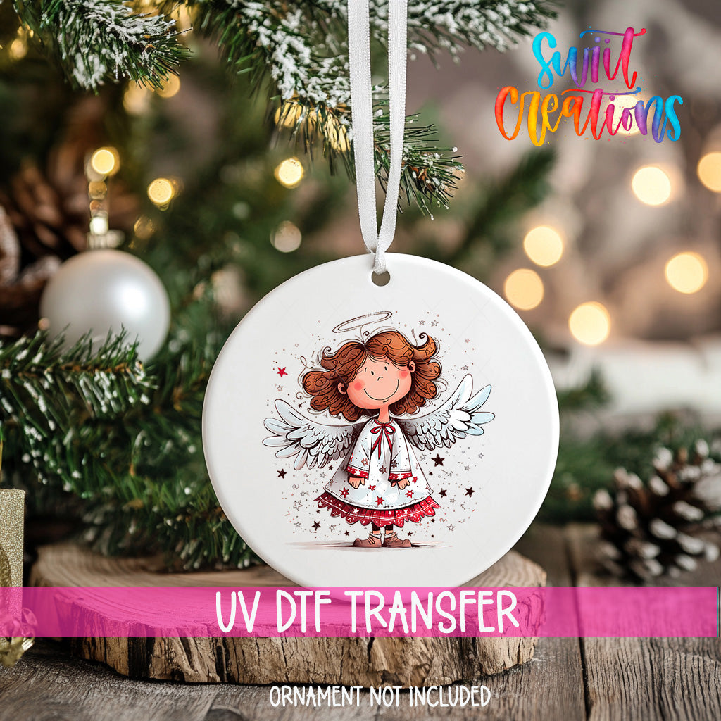 A white ceramic ornament with a smiling angel design hangs on a Christmas tree.