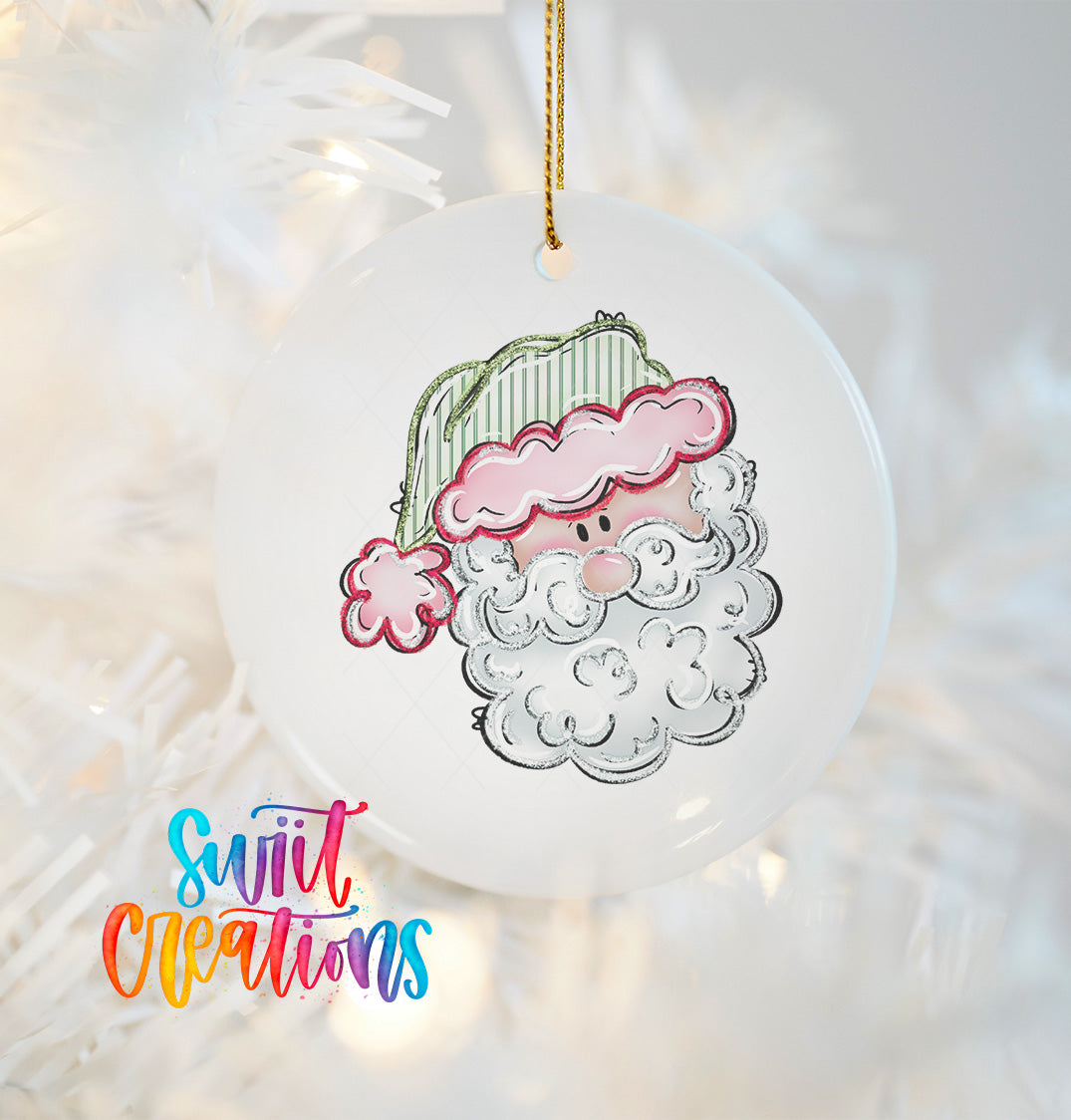 A white ornament with a colorful illustration of a smiling Santa Claus on it, hanging on a string.