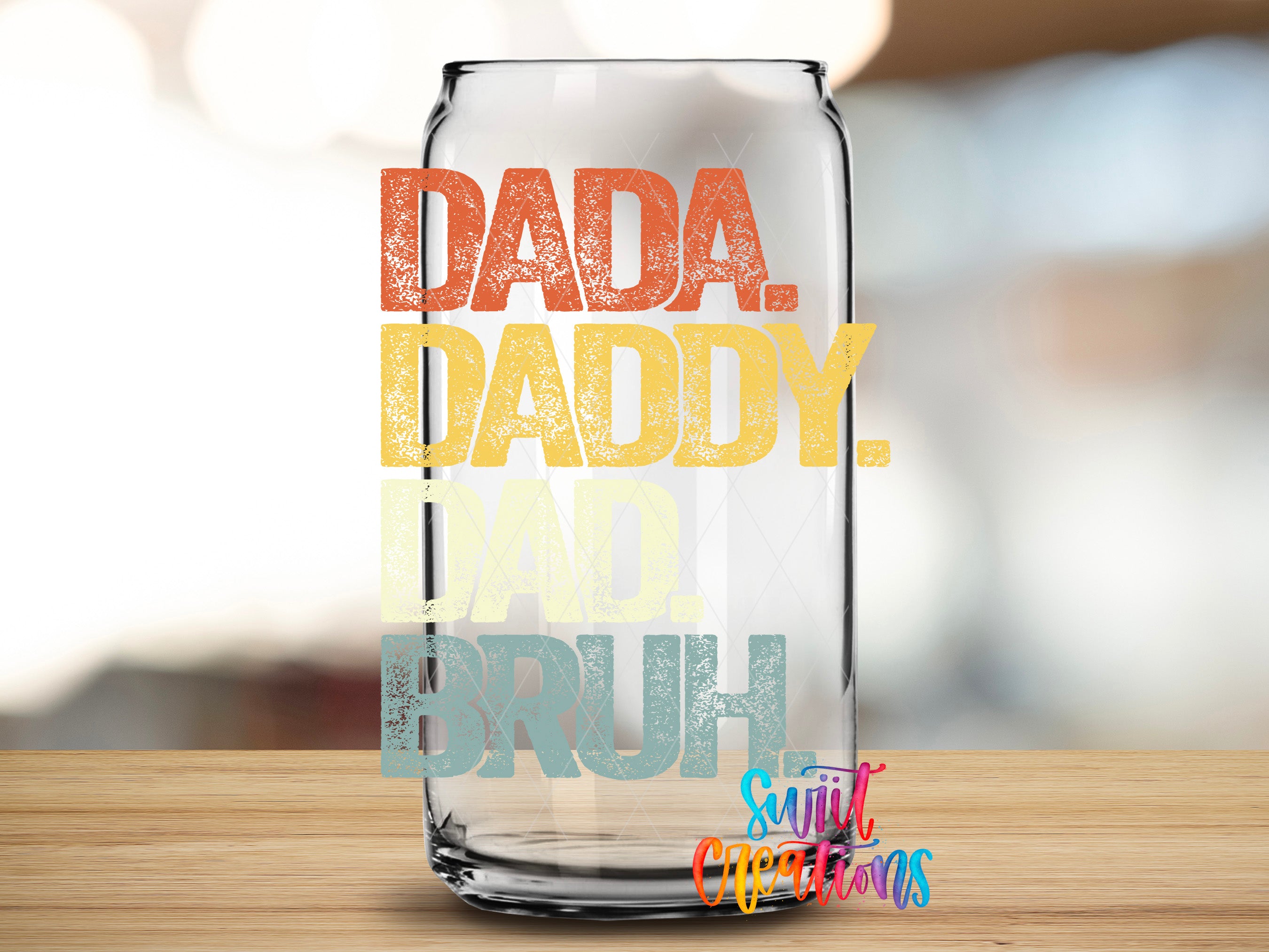 A glass can with text printed on it, placed on a wooden surface.