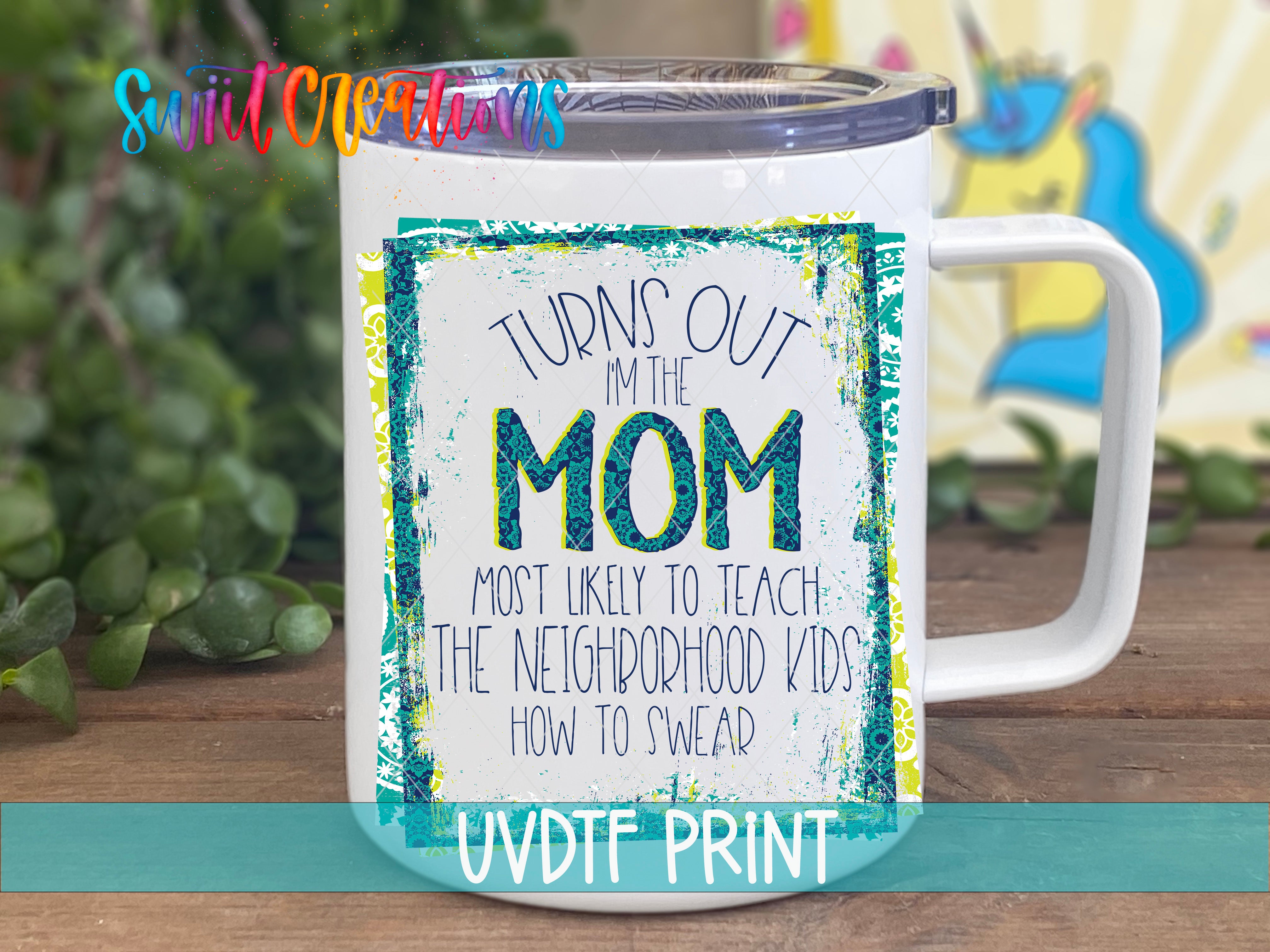 A white mug with a colorful graphic and text printed on it, placed on a wooden surface.