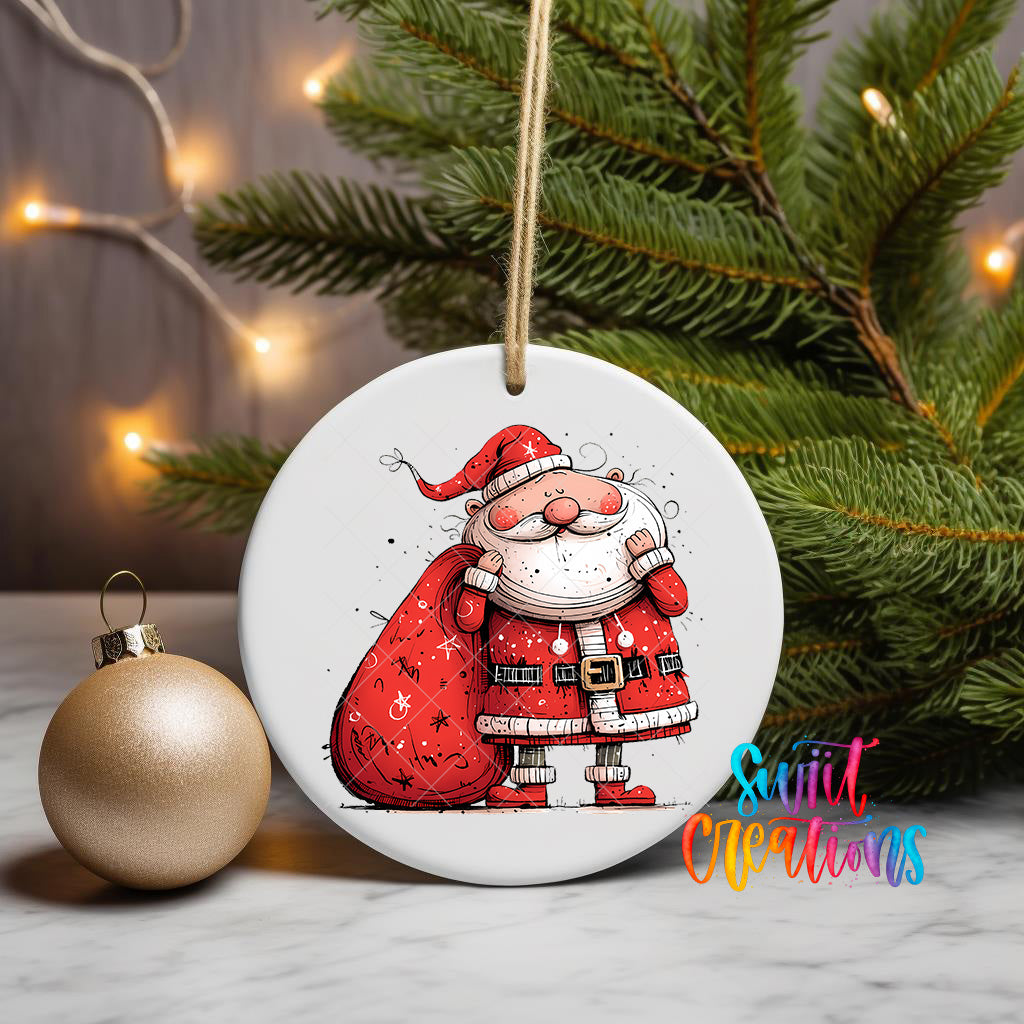 A white ceramic ornament featuring a cartoon Santa Claus figure, with a red sack and a gold ornament on a marble surface in the background.