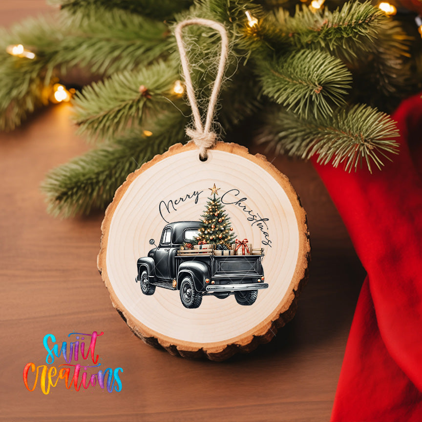 A wooden ornament hanging on a Christmas tree, featuring a vintage truck with a Christmas tree in its bed.
