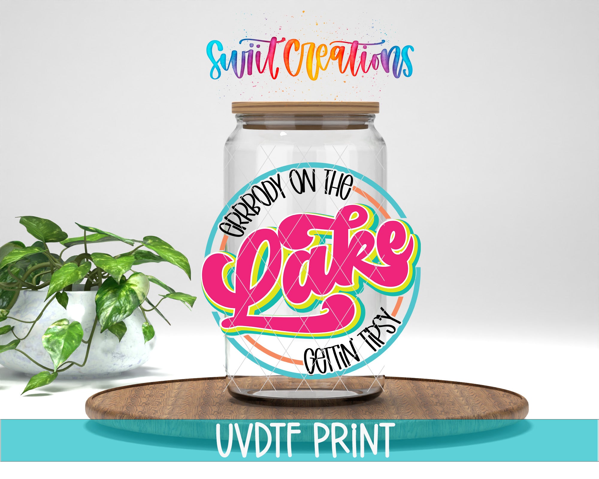 a glass jar with a colorful label that says "GIRBODY ON THE LAKE GETtin Tipsy" and is placed on a wooden surface. There is also a potted plant in the background.