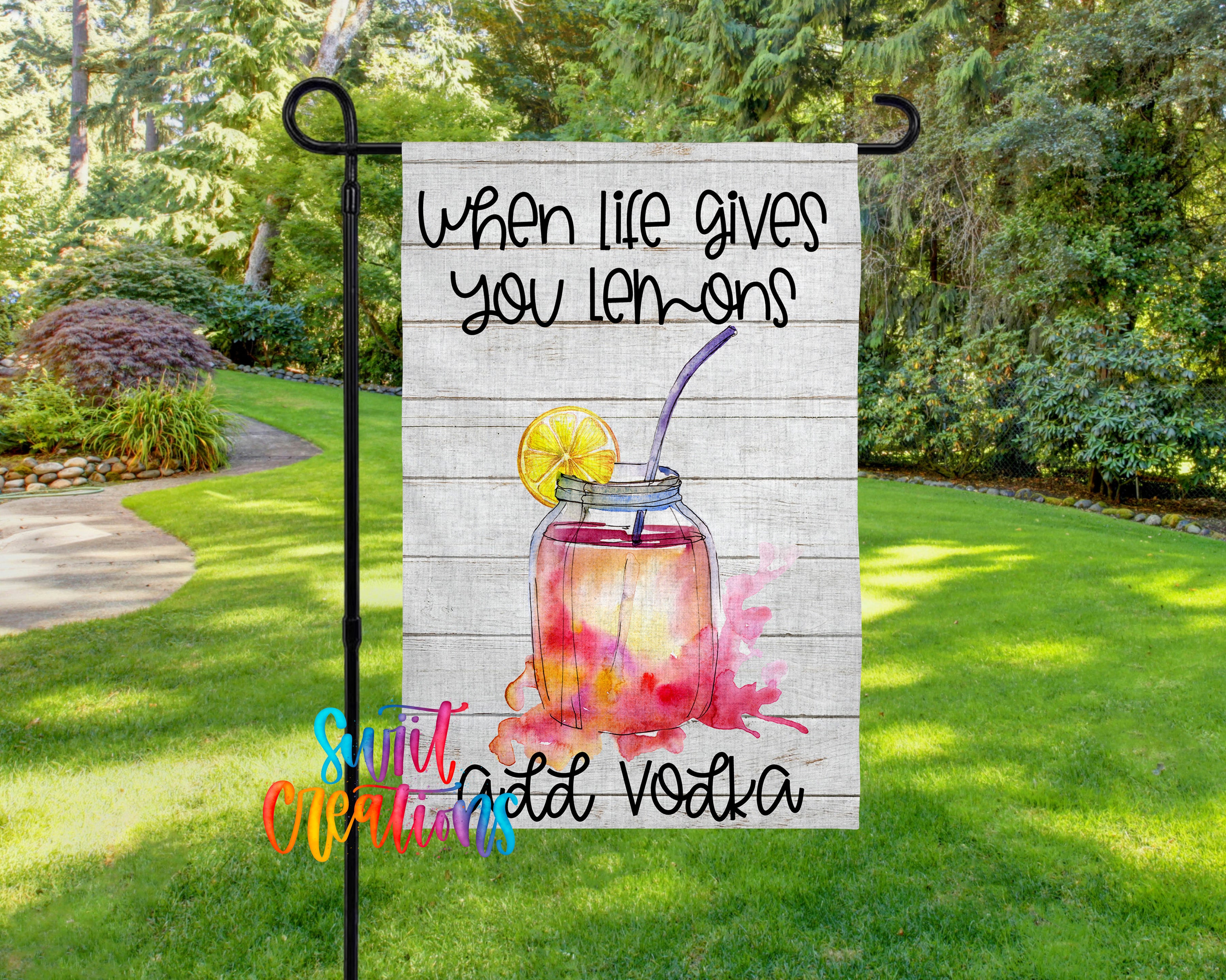 A garden sign with a lemonade drink and the text "When life gives you lemons, you add vodka" displayed on it.