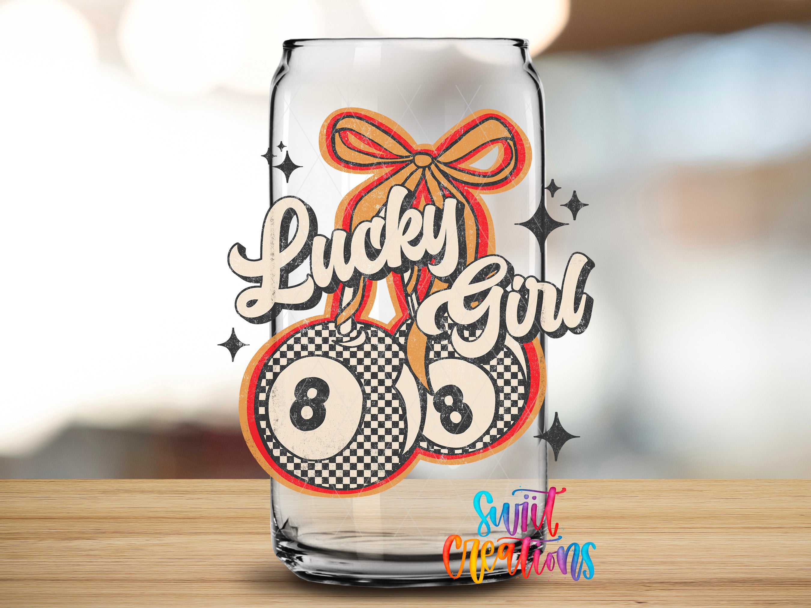 A glass can with a design featuring a ribbon and the text "Lucky Girl" along with a checkerboard pattern and the number "8".