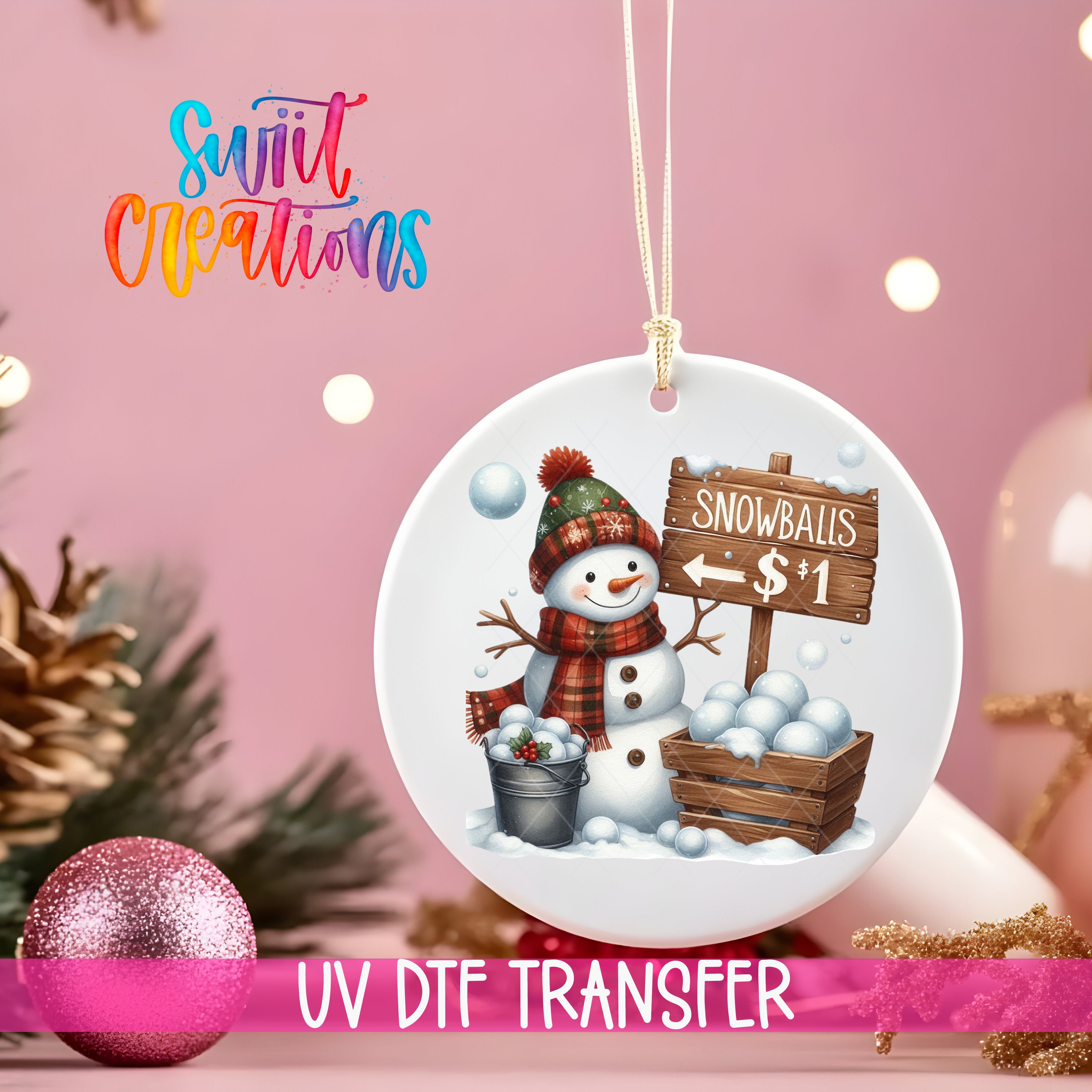 A snowman ornament with a sign that says "Snowballs $1" is hanging on a pink background, surrounded by Christmas decorations and a pink glitter ornament.