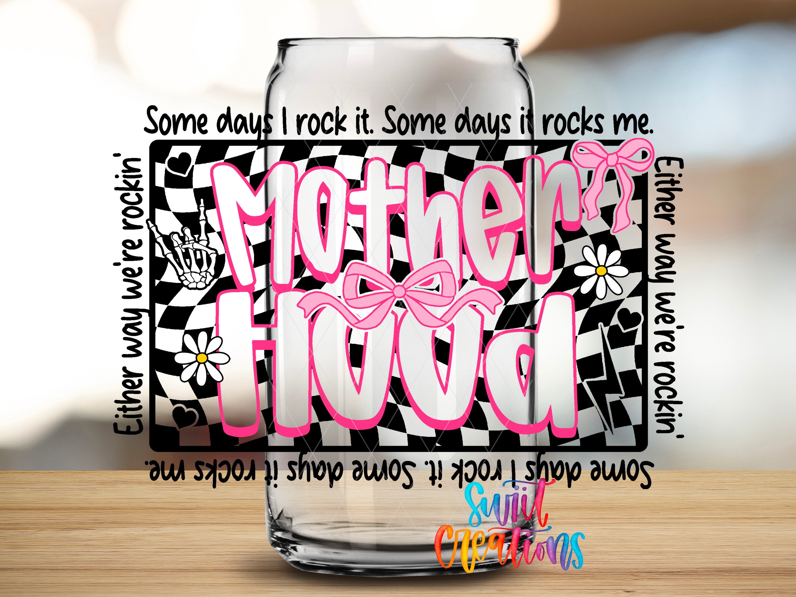a glass jar with a creative design and text that reads "Motherhood".