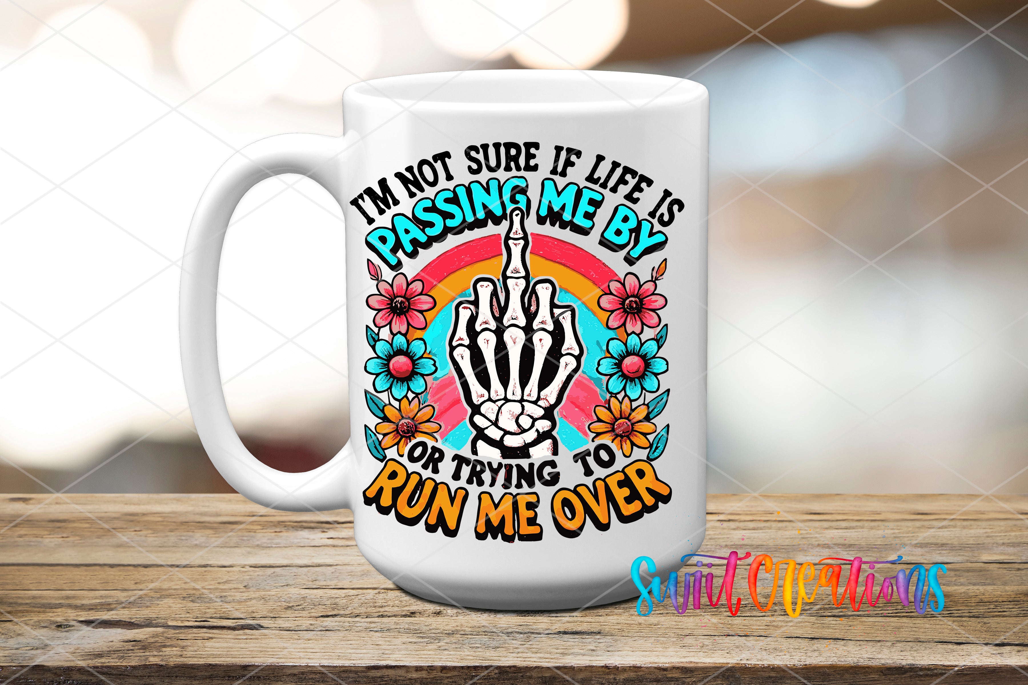 A white ceramic mug with a colorful graphic design featuring a skeleton hand making a peace sign, surrounded by flowers and a rainbow.
