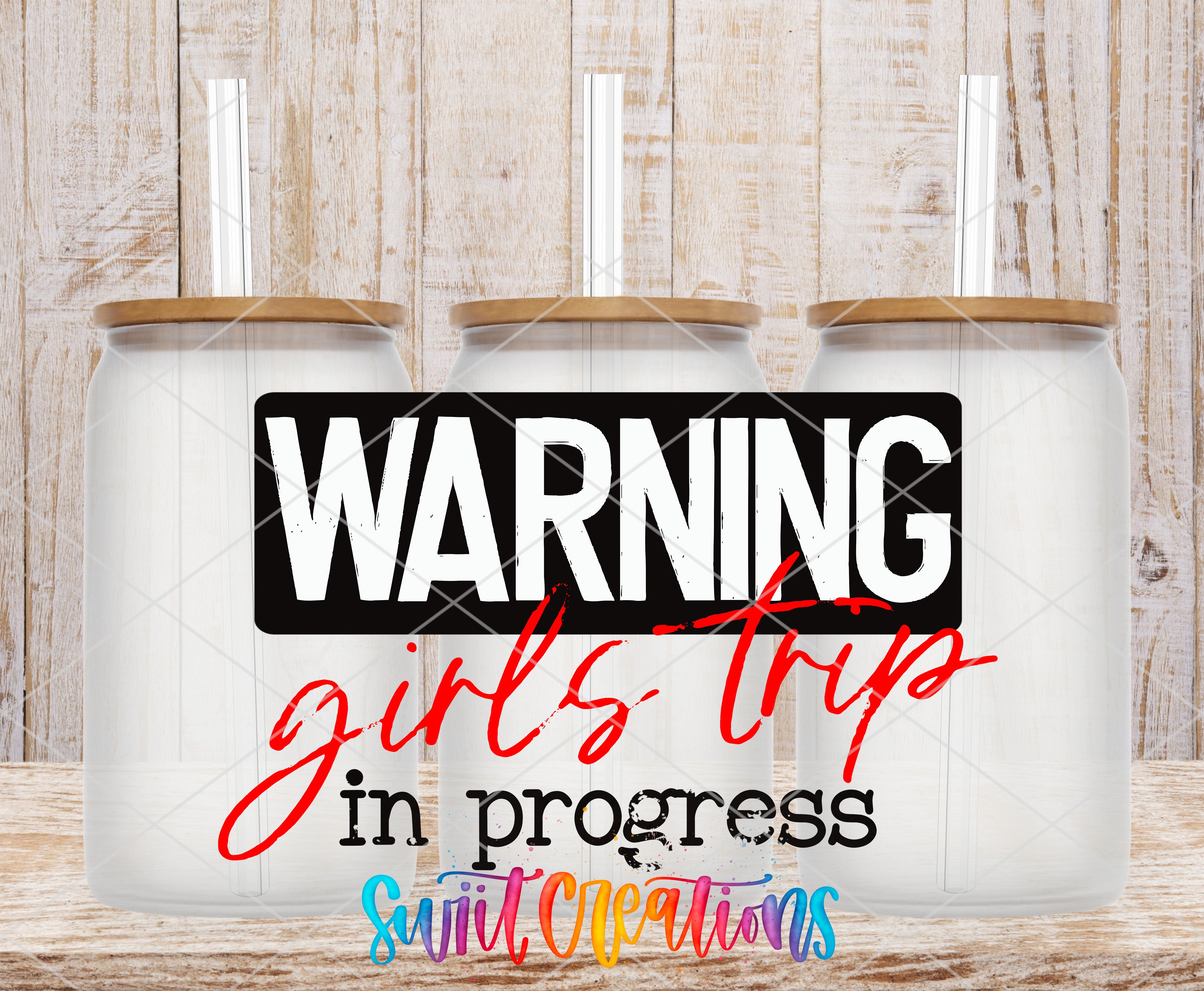 three clear glass jars with wooden lids, each with a straw, arranged in a row against a wooden background. The text "WARNING girls trip in progress" is displayed prominently in the center of the image.