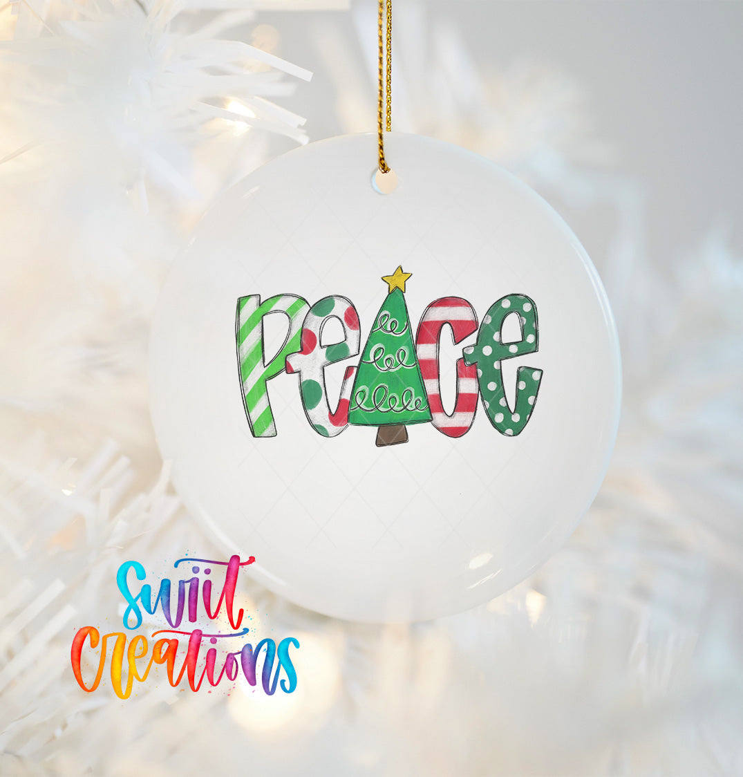 A white ornament with the word "Peace" written on it, hanging on a Christmas tree.