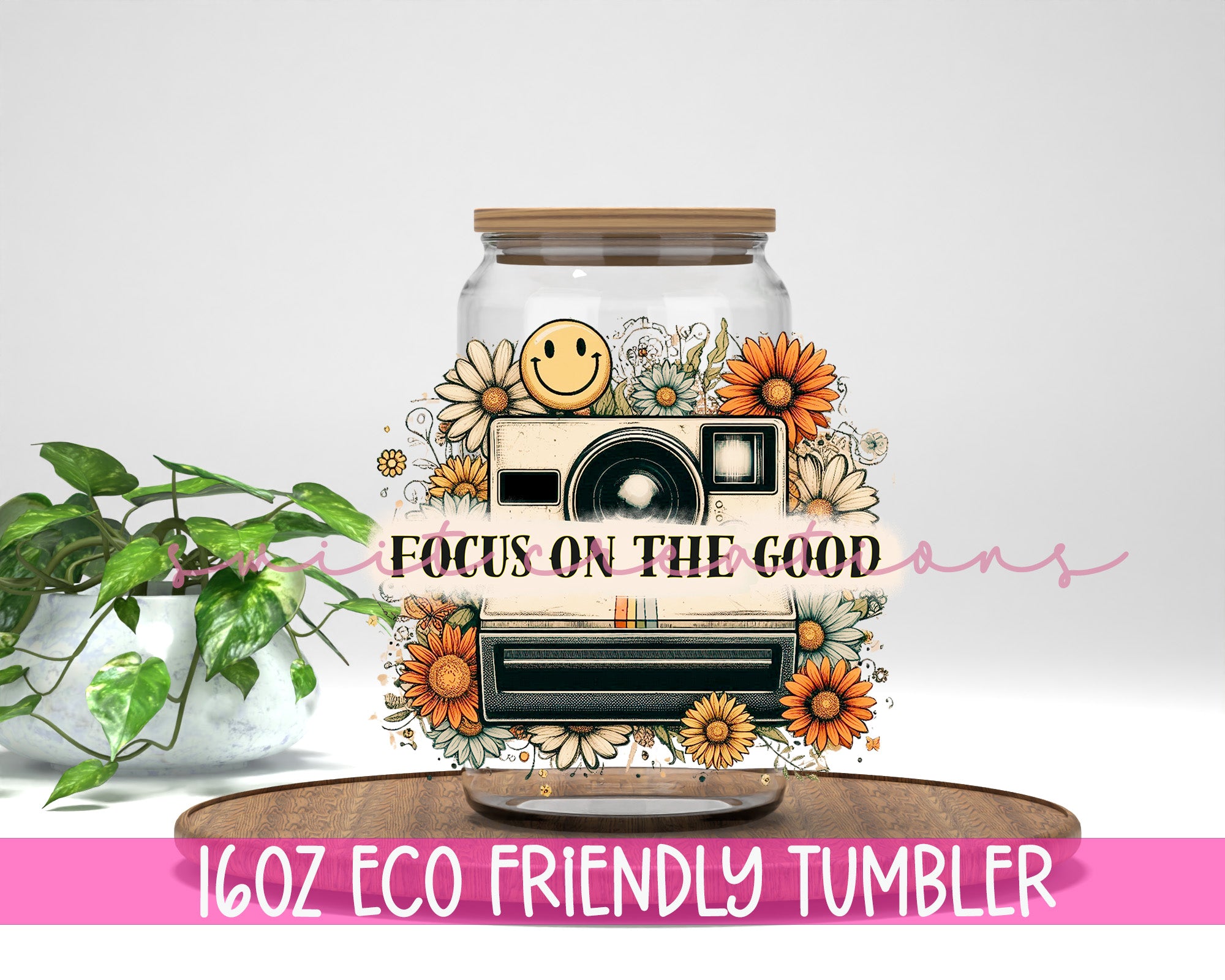 a glass jar with flowers and a camera