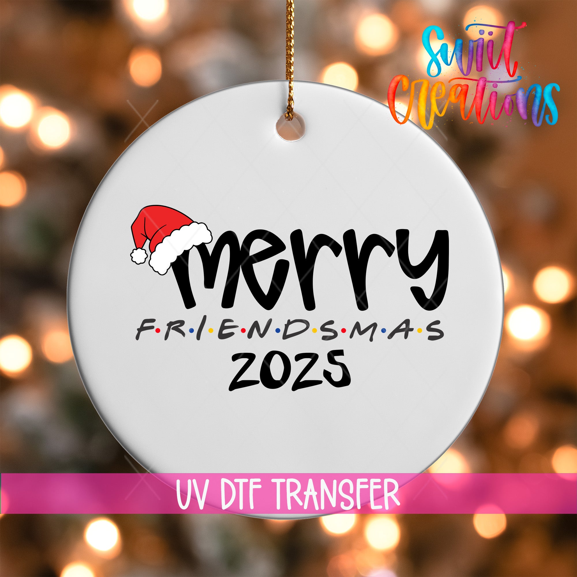 A white ornament with the text "MERRY FRIENDS M.A.S. 2025" and a Santa hat graphic, hanging against a background of colorful lights.