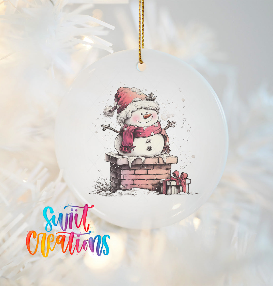 A white ornament with a snowman and presents hanging on a string.